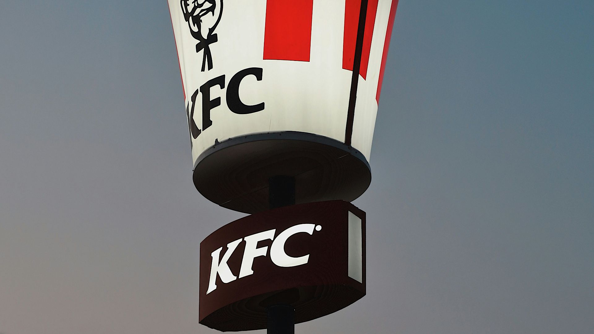a kfc sign with a man's face on it