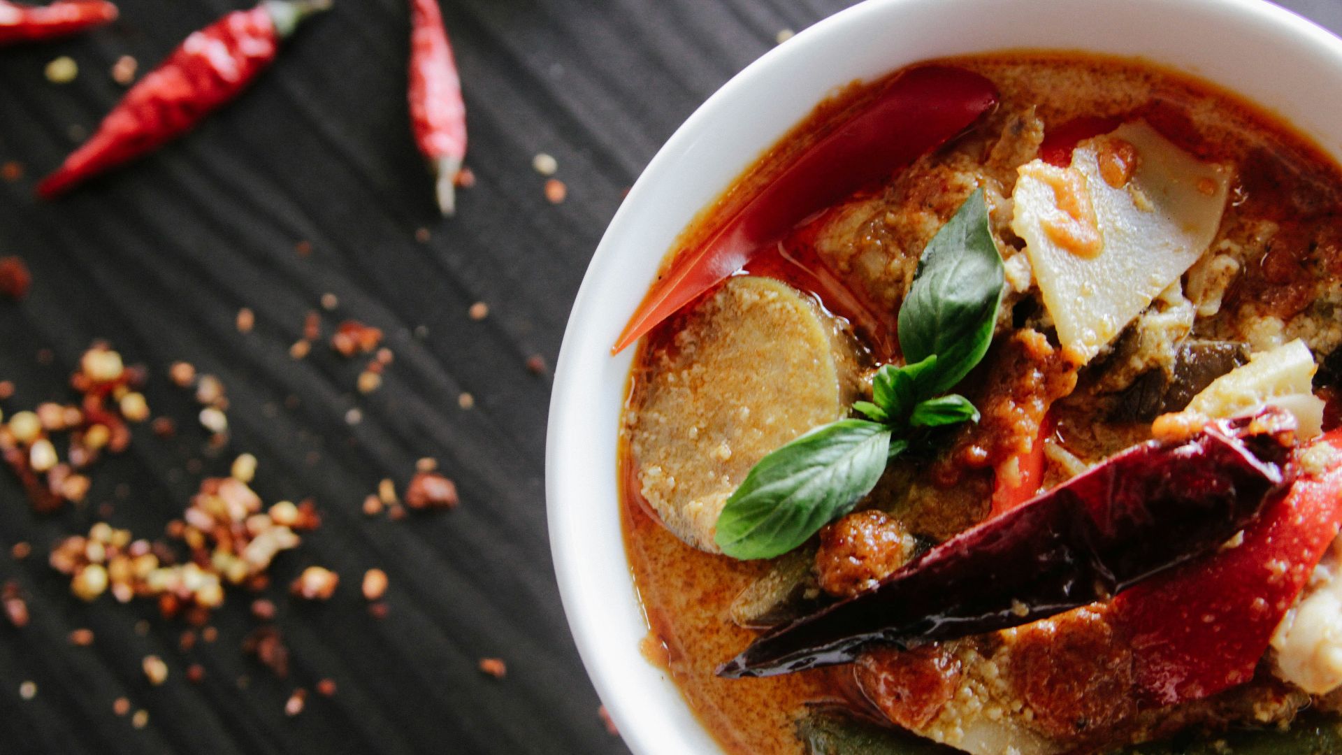 flat-lay photography of vegetable soup on white ceramic cup