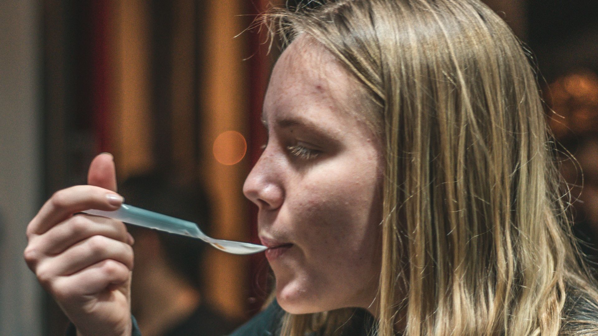 woman in black long-sleeved top facing sideways