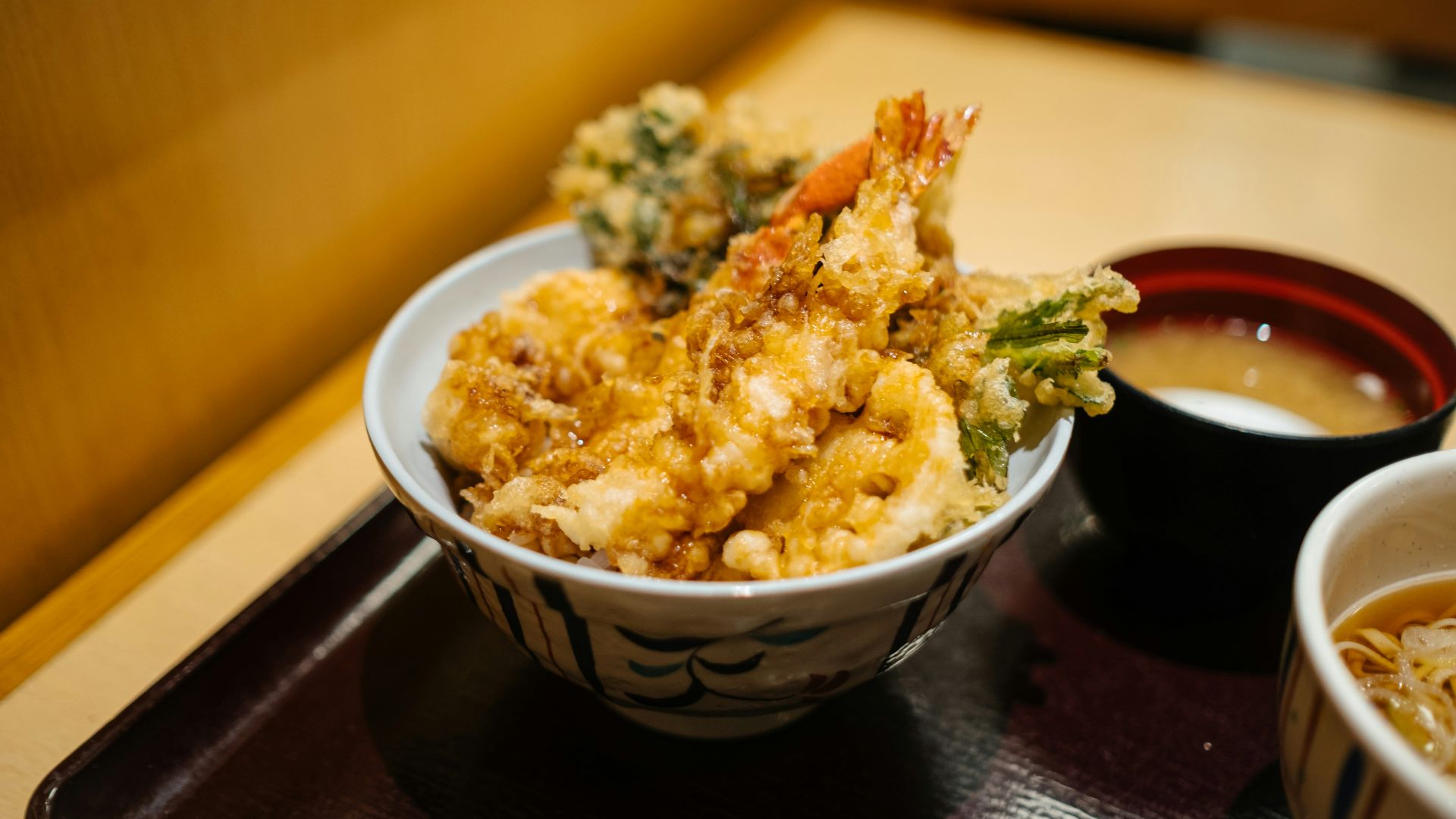 brown rice on white and blue ceramic bowl