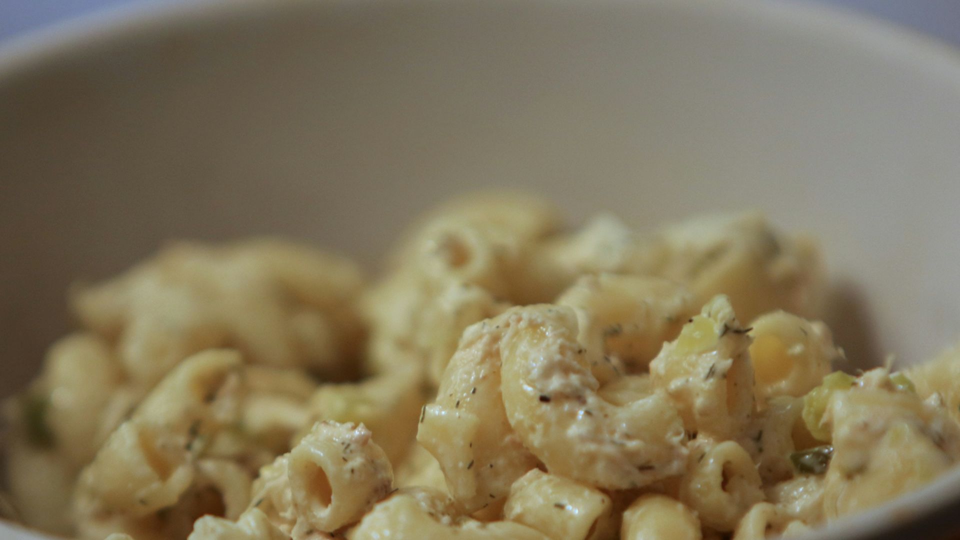 a bowl of macaroni and cheese with a spoon in it
