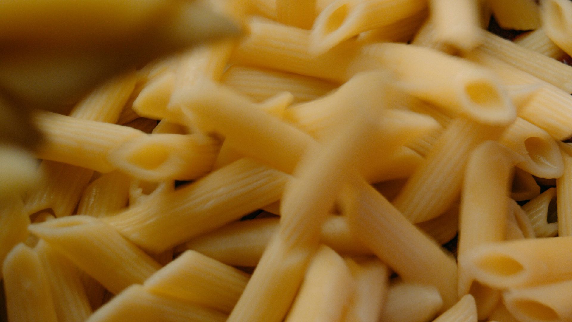 yellow pasta on black ceramic bowl