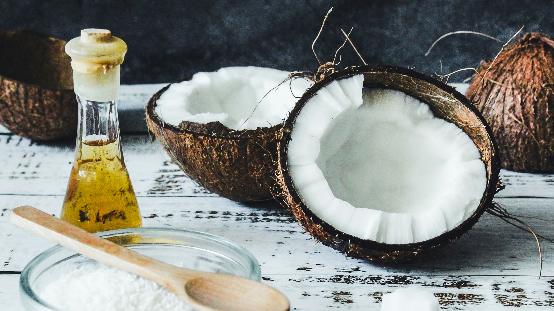 white powder in clear glass jar beside brown wooden spoon
