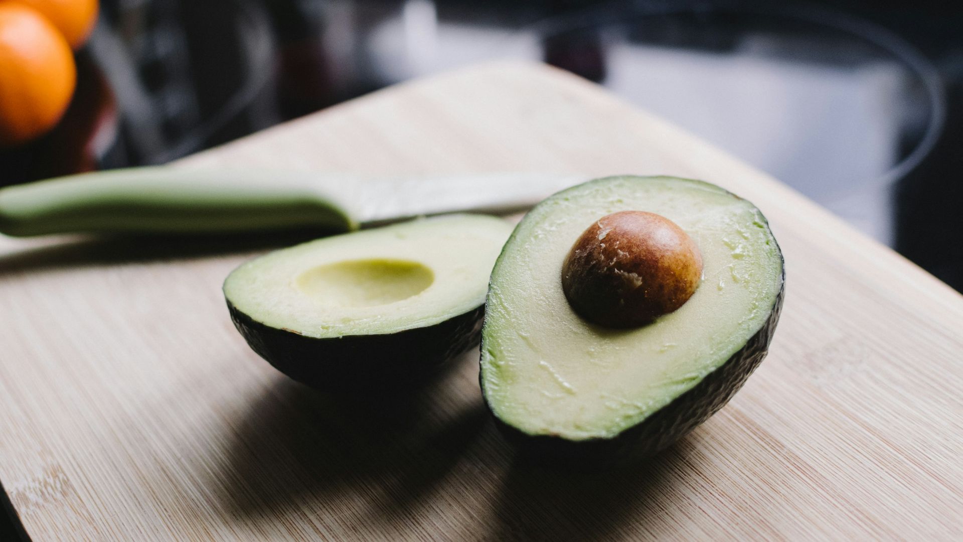 sliced avocado on brown wooden chopping board