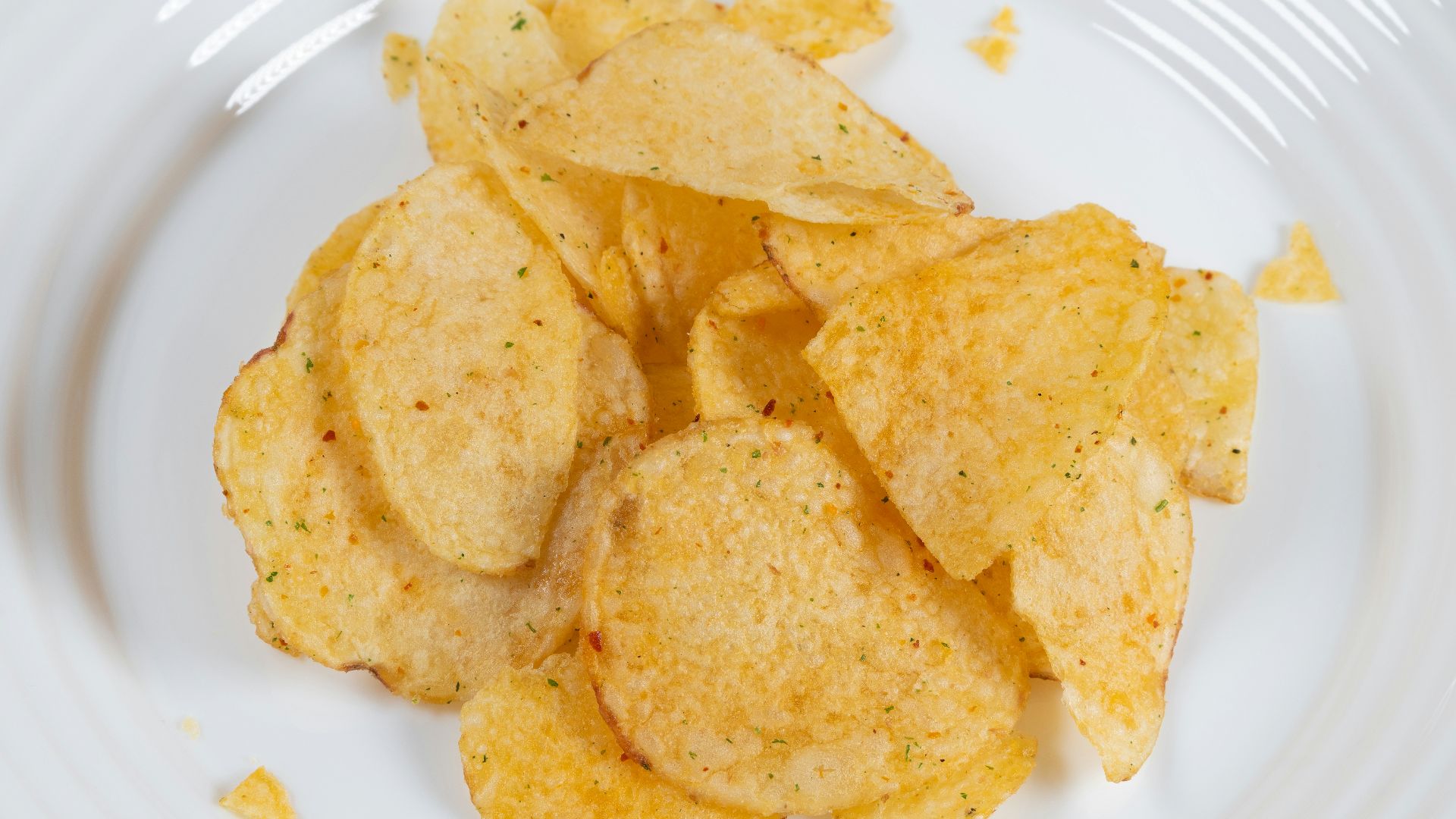 a white plate topped with chips on top of a table