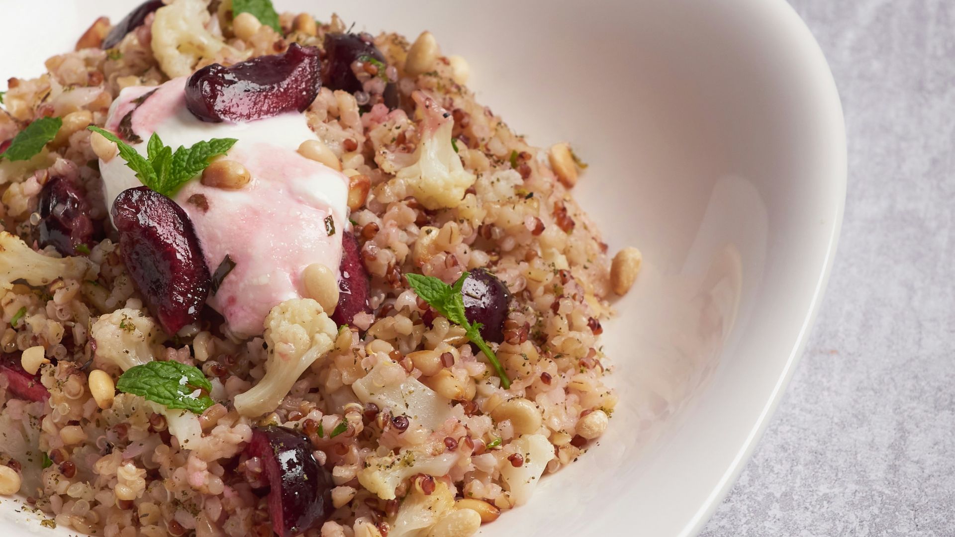 a white bowl filled with food on top of a table