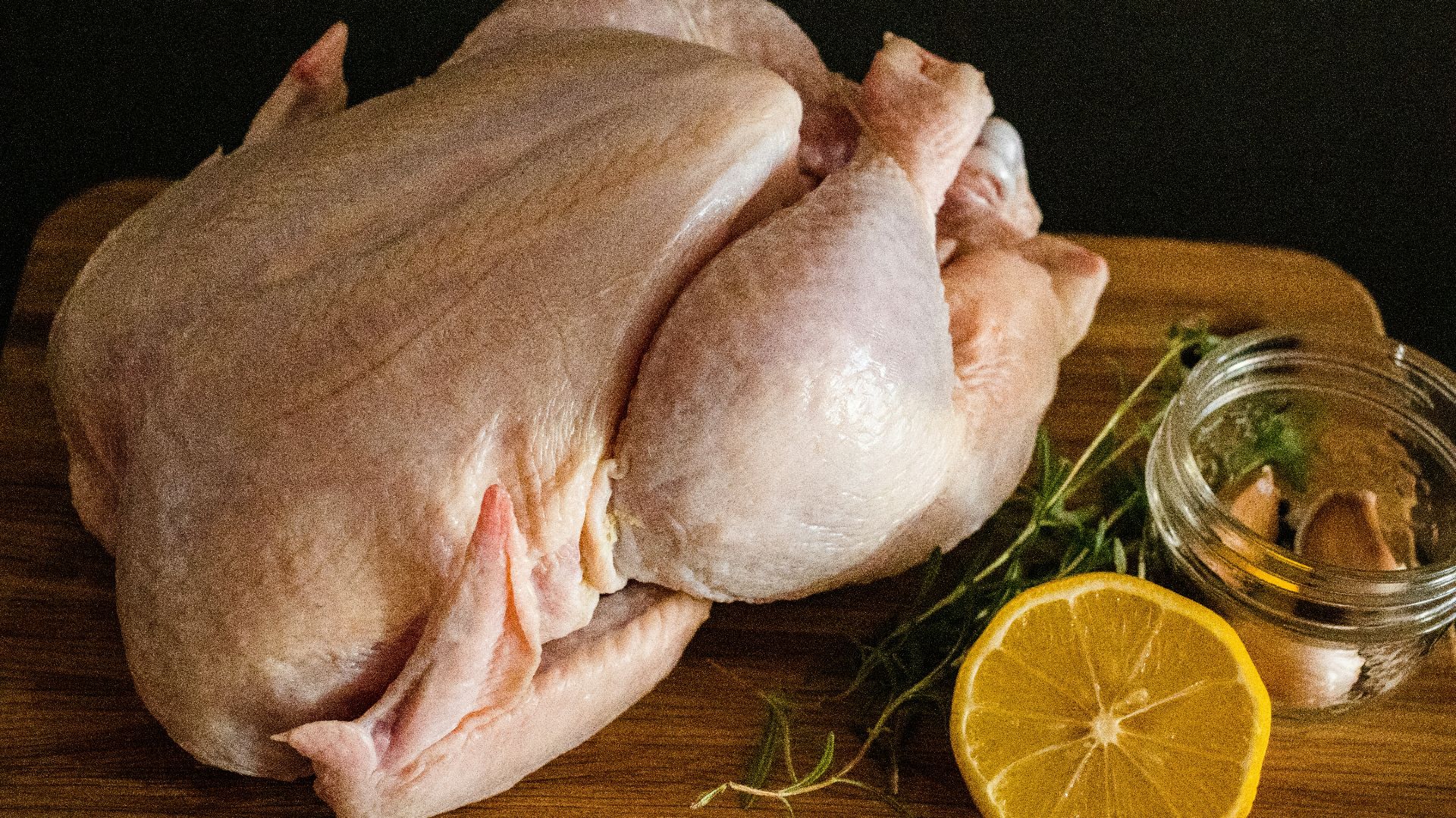 raw chicken meat on brown wooden chopping board