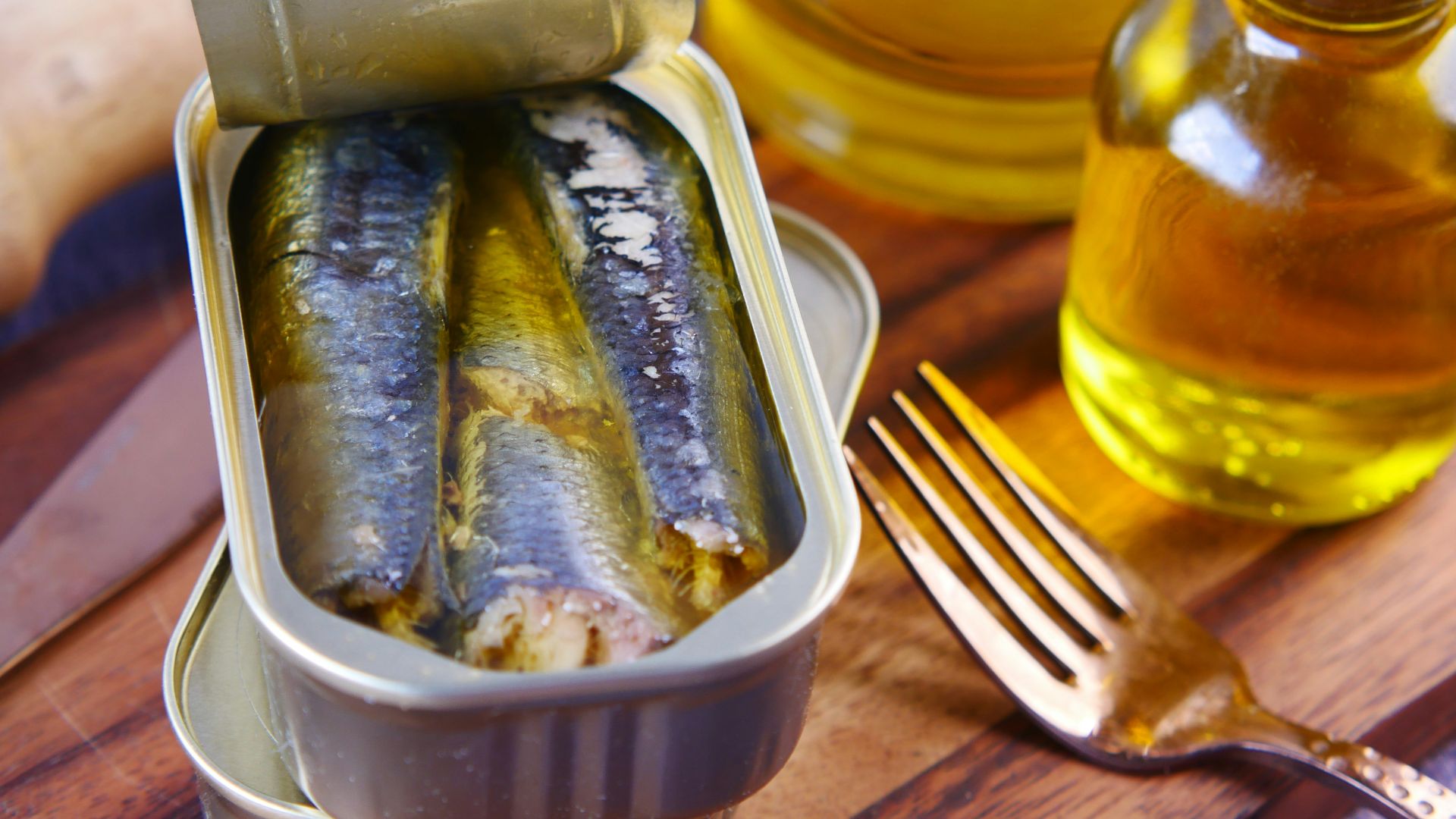 a tin of sardines sitting on top of a wooden table