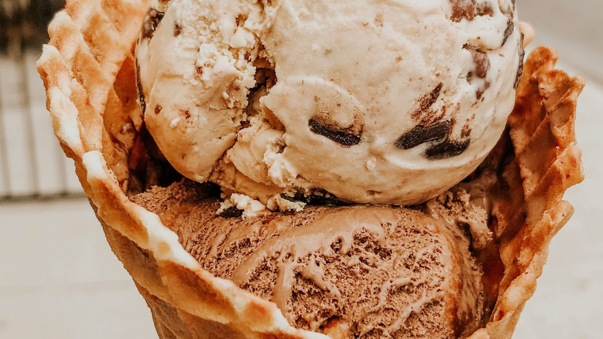 person holding ice cream in cone