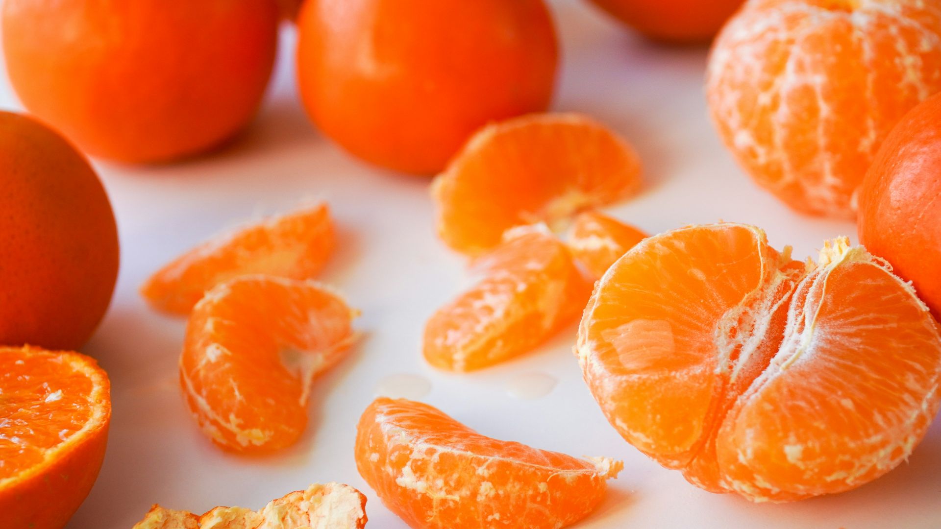 sliced orange fruits on white ceramic plate
