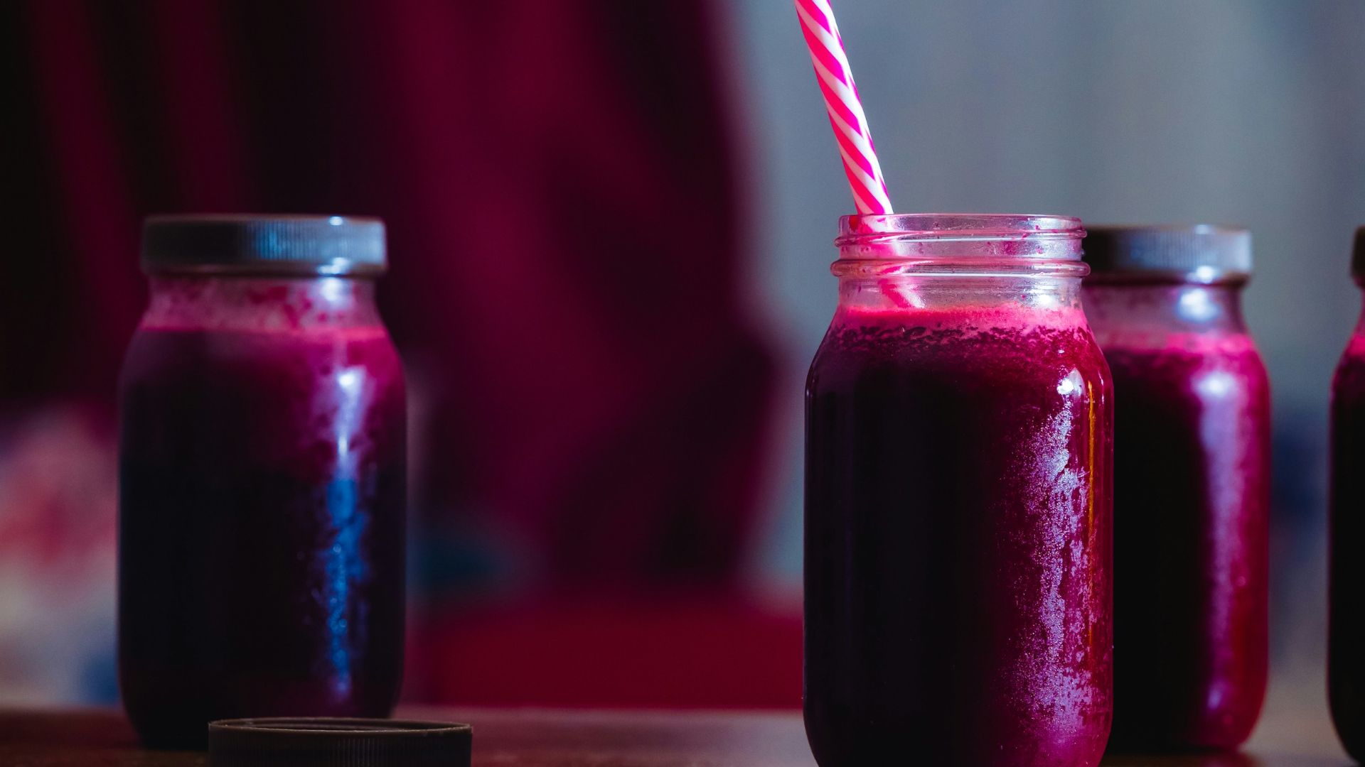 red beverage in mason jars