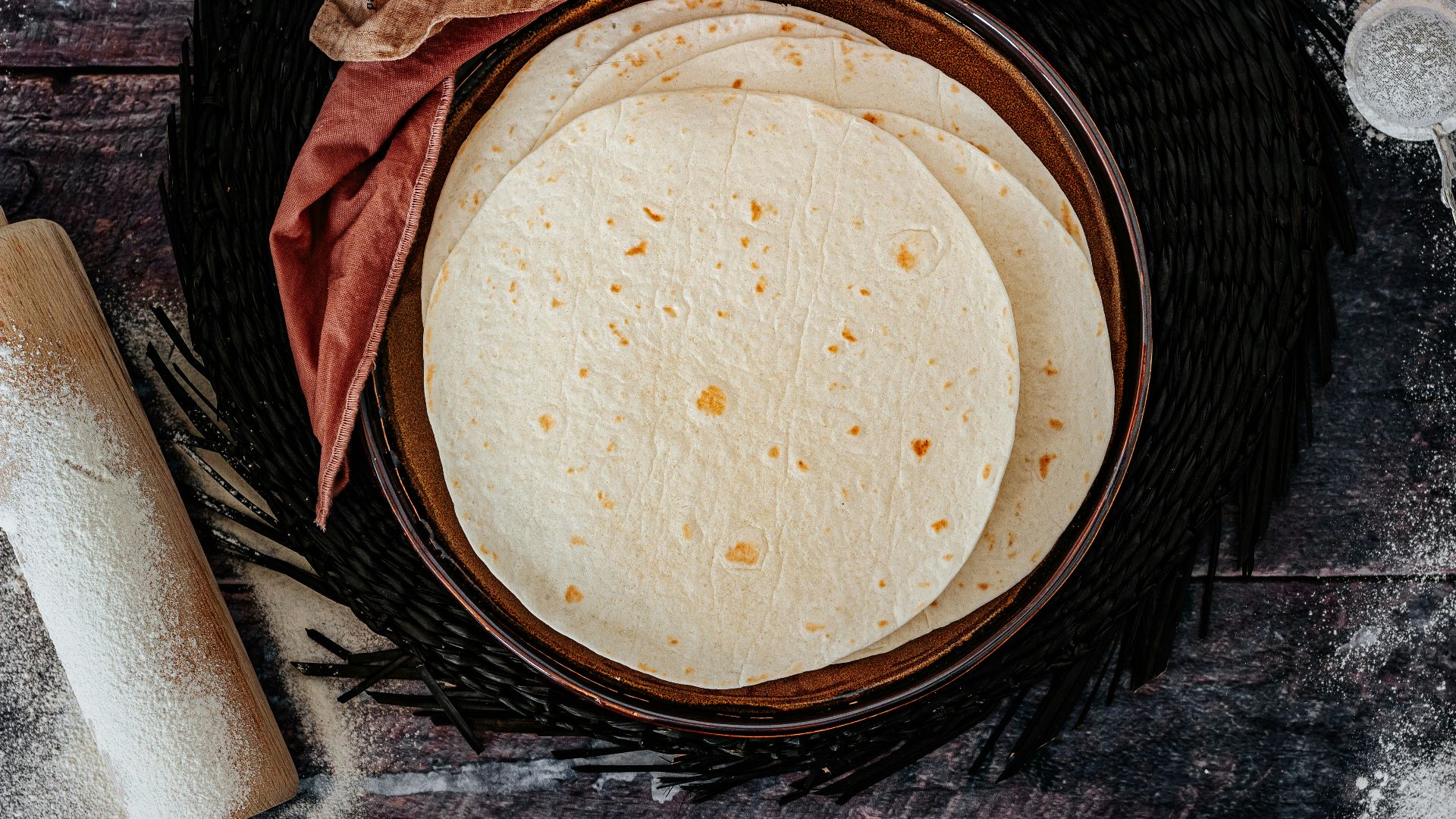 brown woven round basket on black and gray textile
