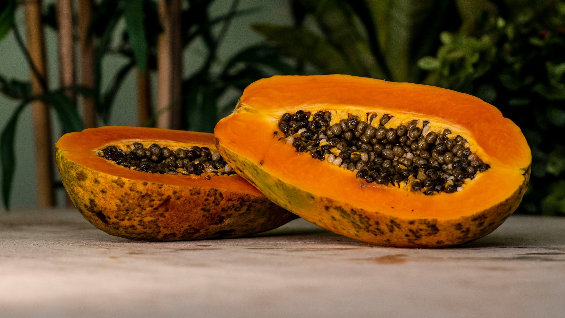 sliced papaya fruits on brown surface