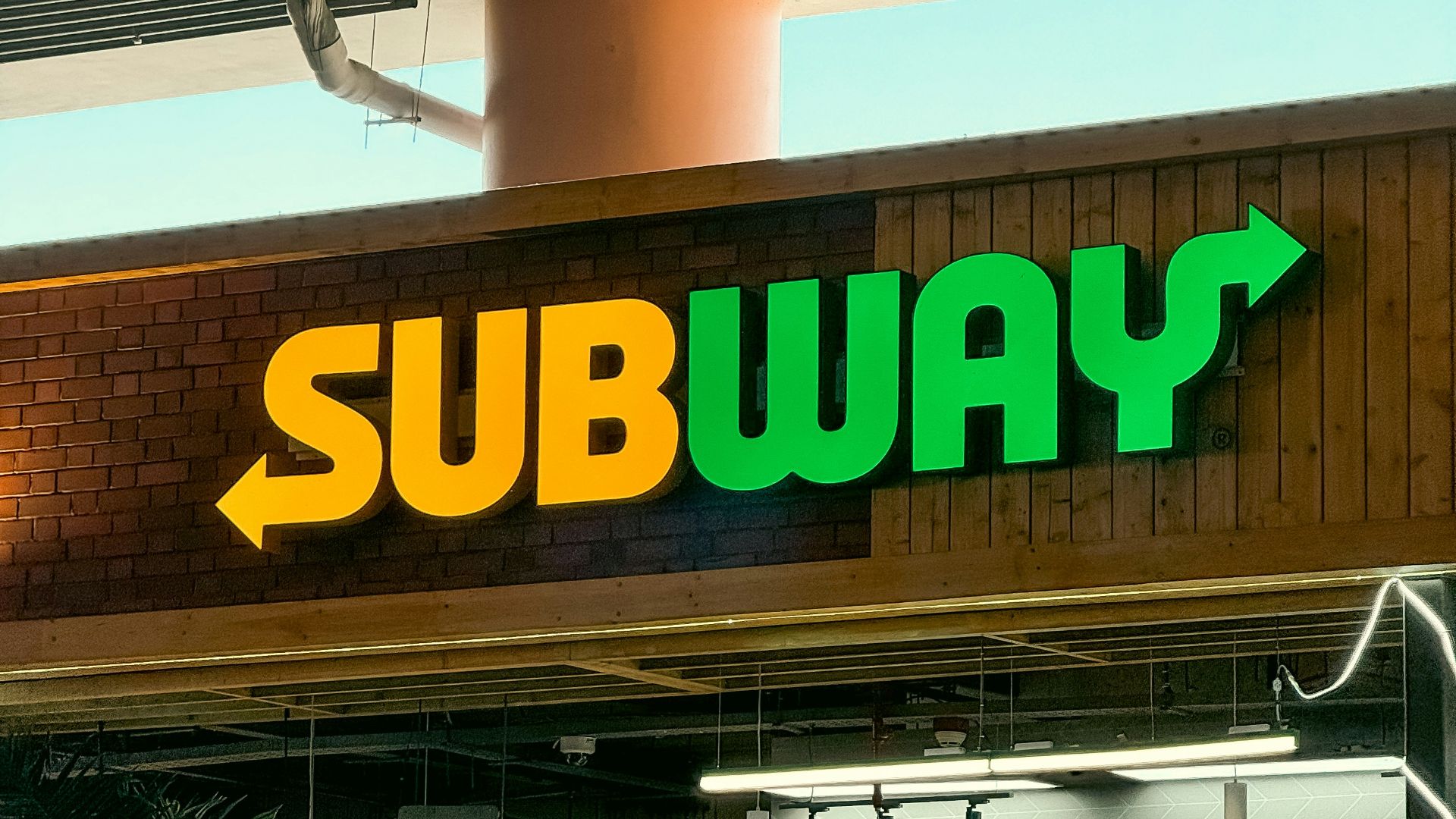 a subway sign above a subway entrance