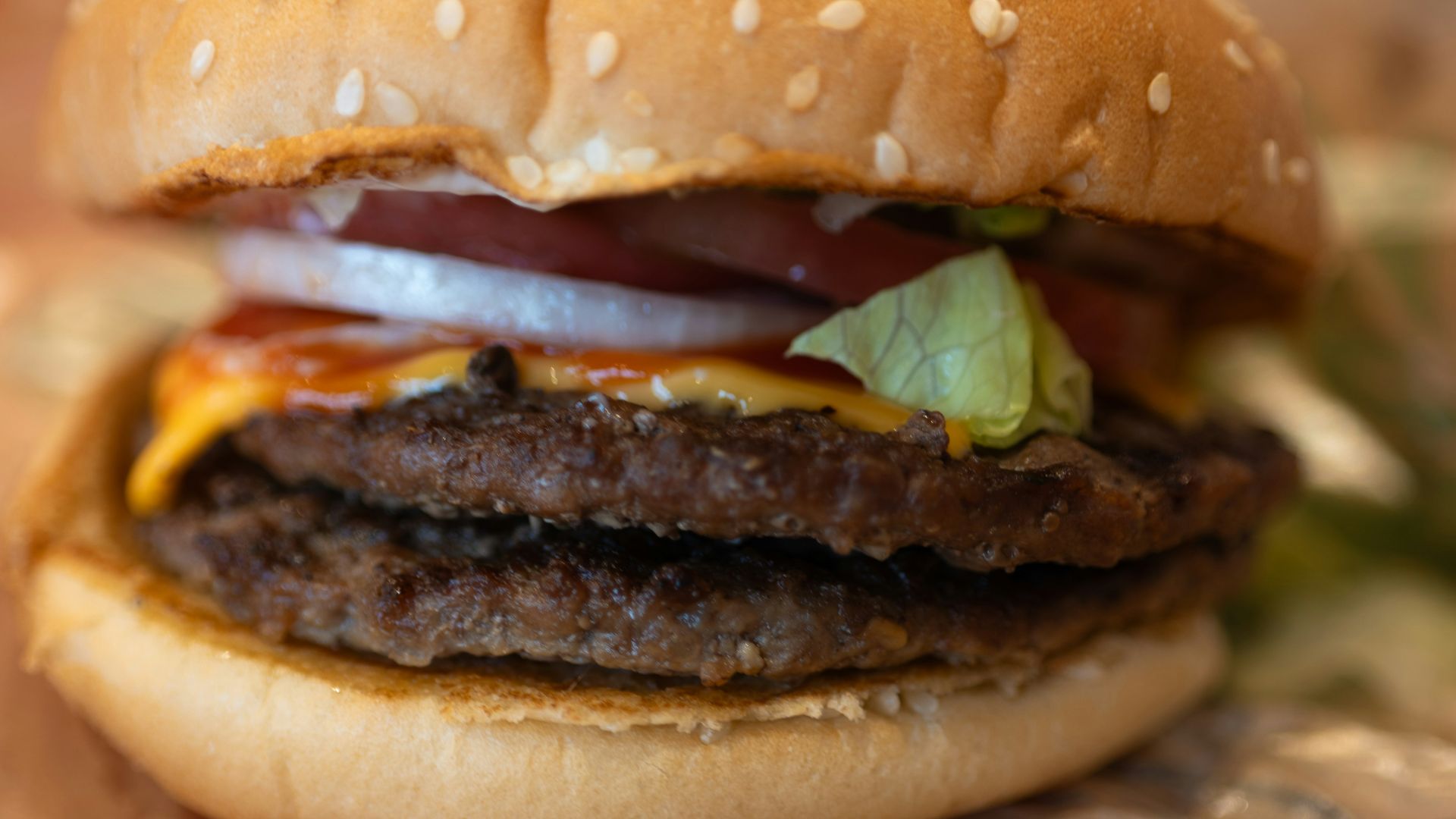 A delicious double burger is ready to be eaten.
