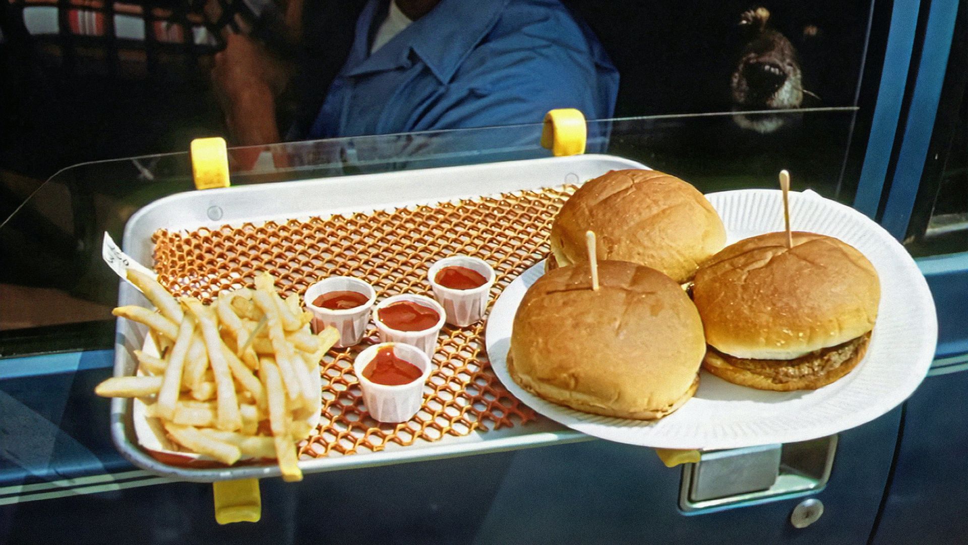 a tray with two hamburgers and french fries on it