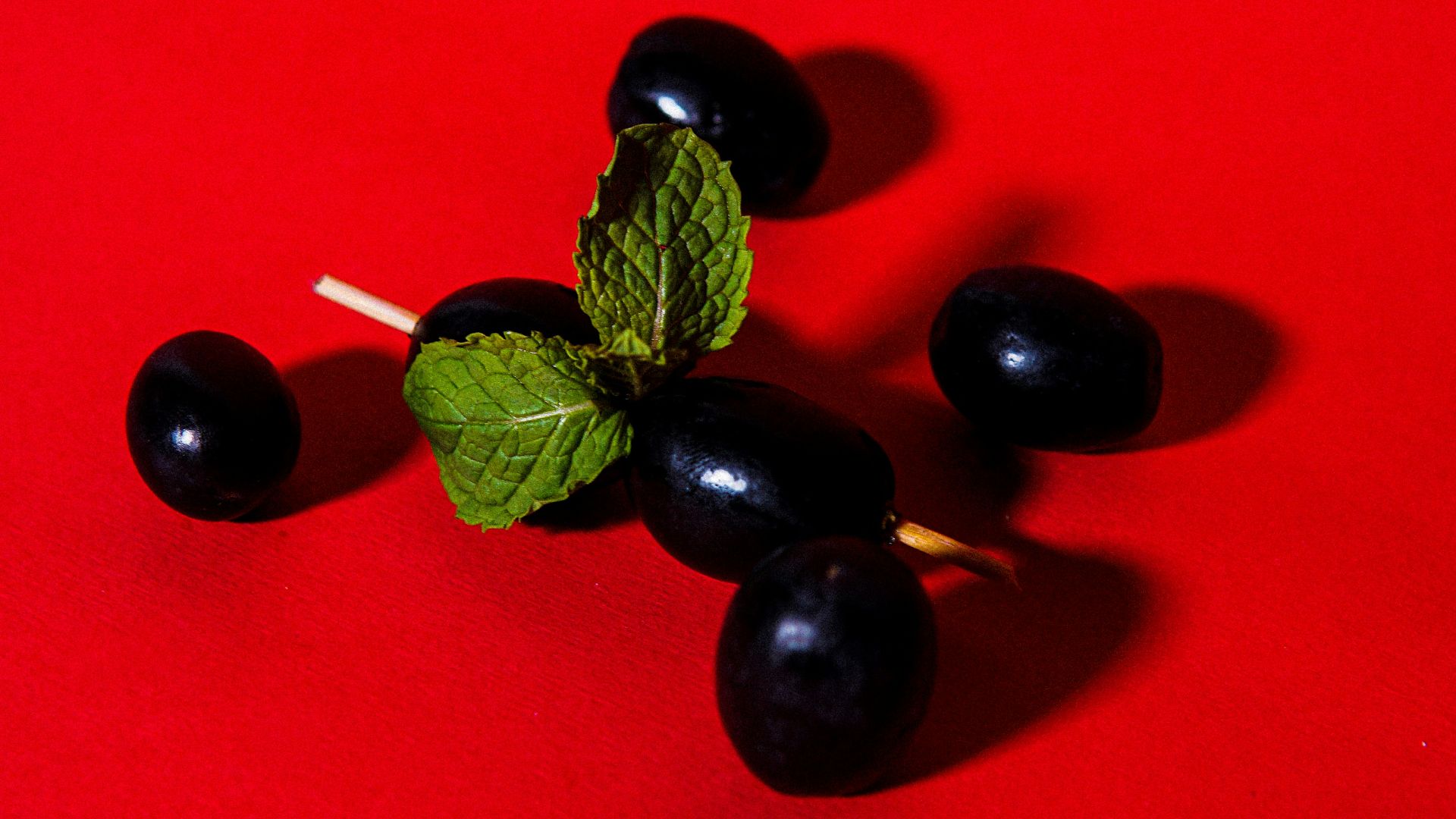 red and black berries on red textile