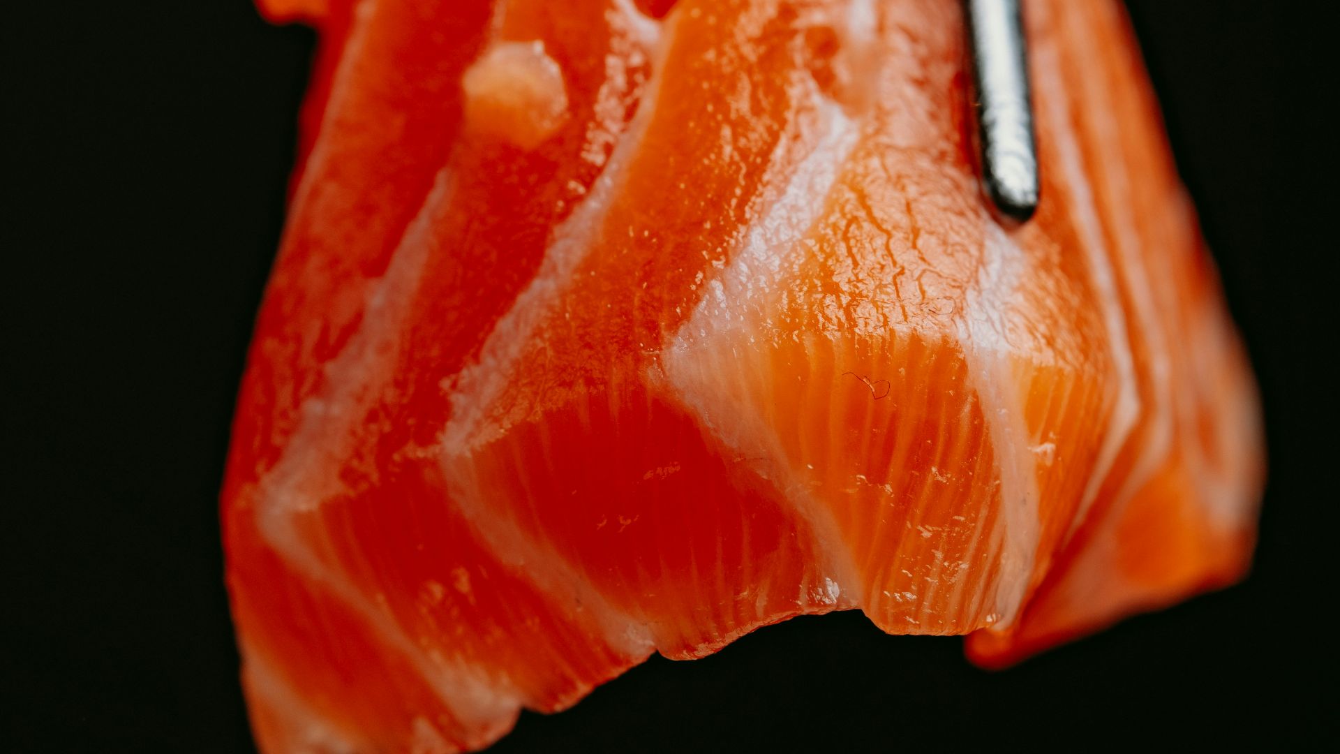 a piece of sushi with chopsticks sticking out of it