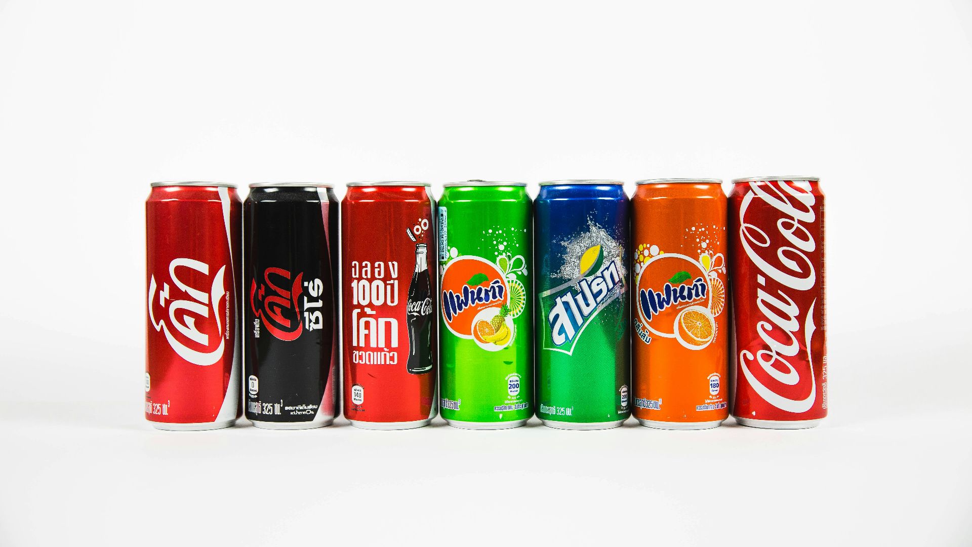 seven assorted-brand soda cans