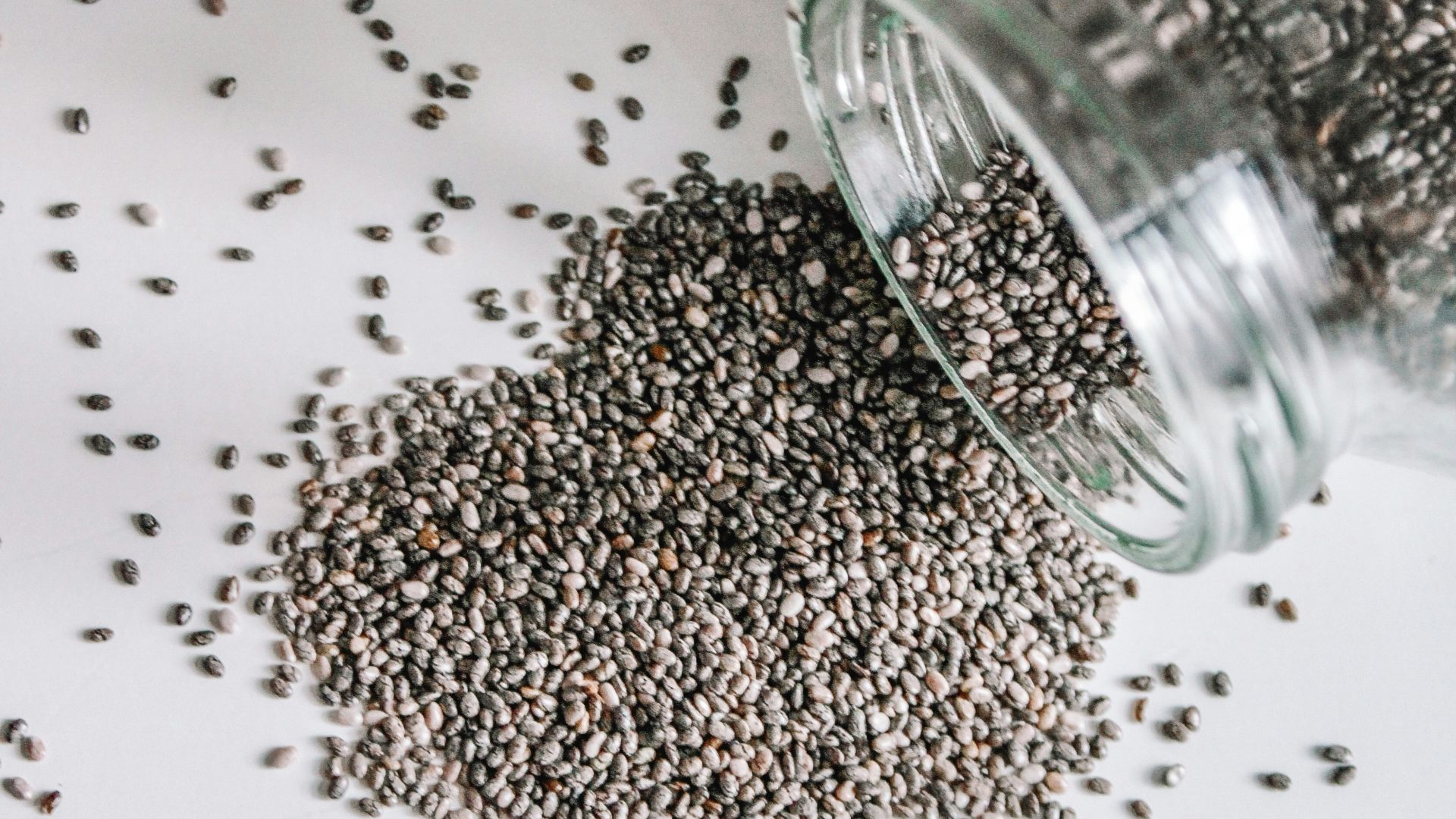 black beads in clear glass jar