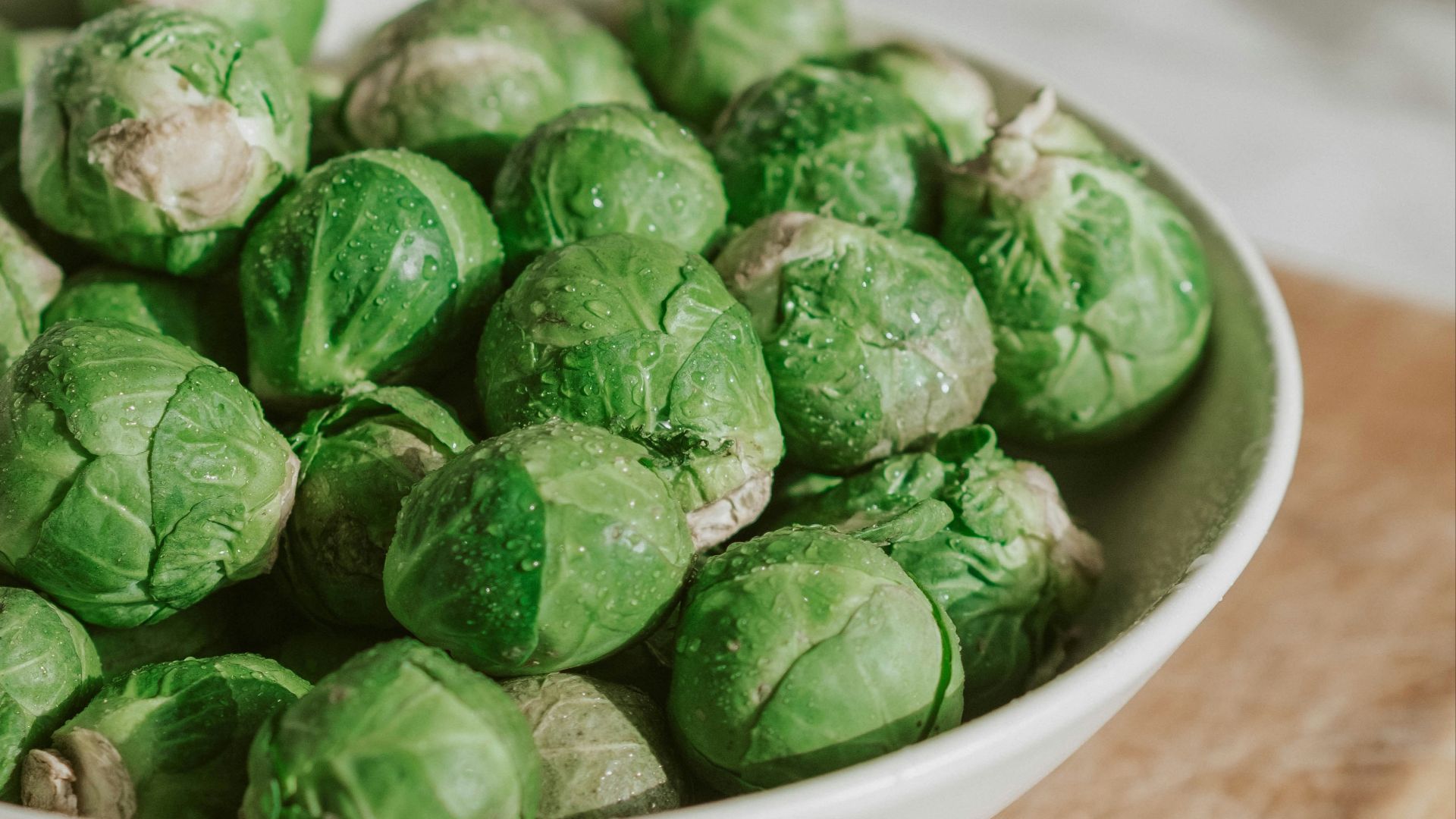 green vegetable on white ceramic bowl