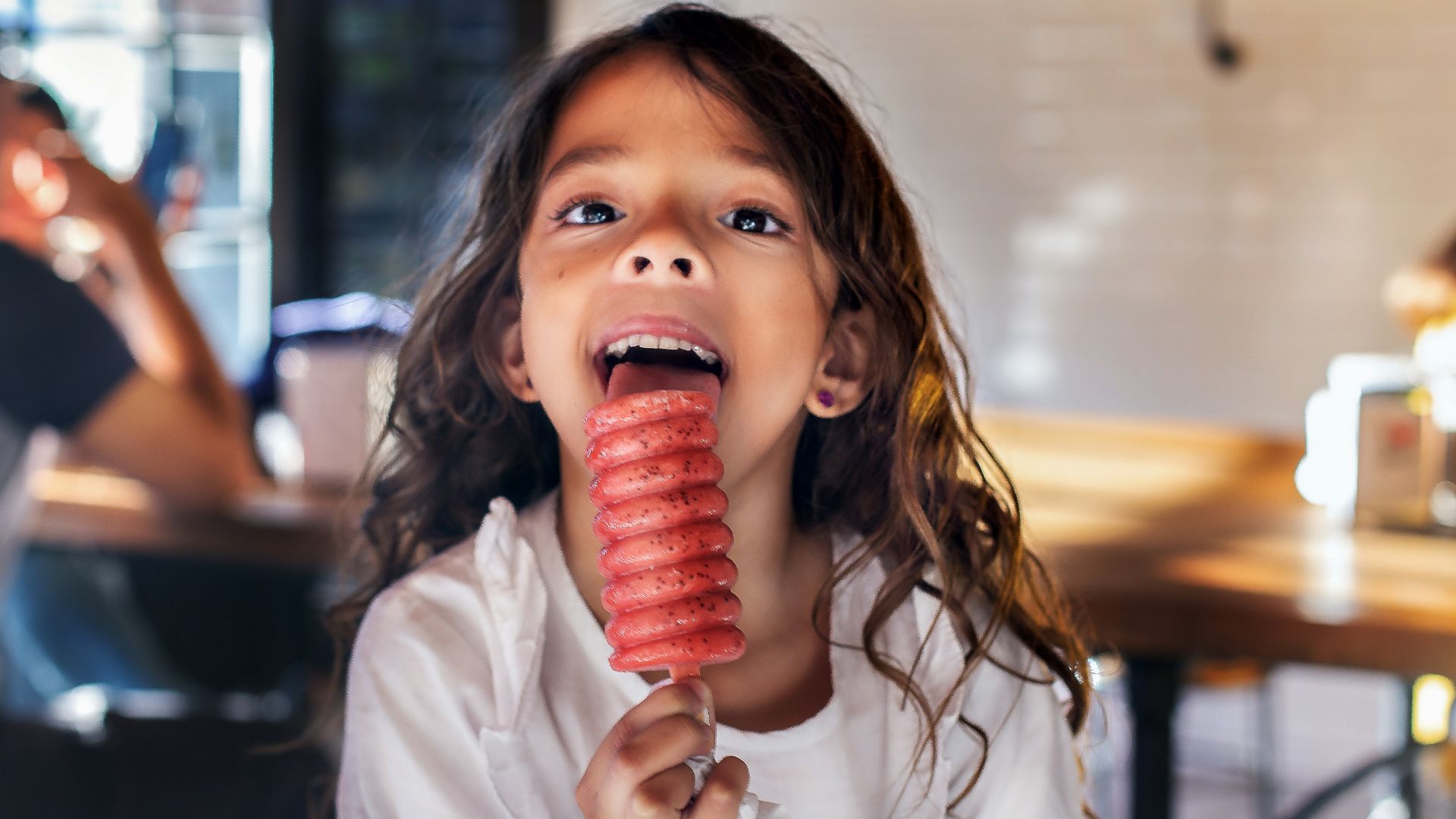 girl licking popsicle