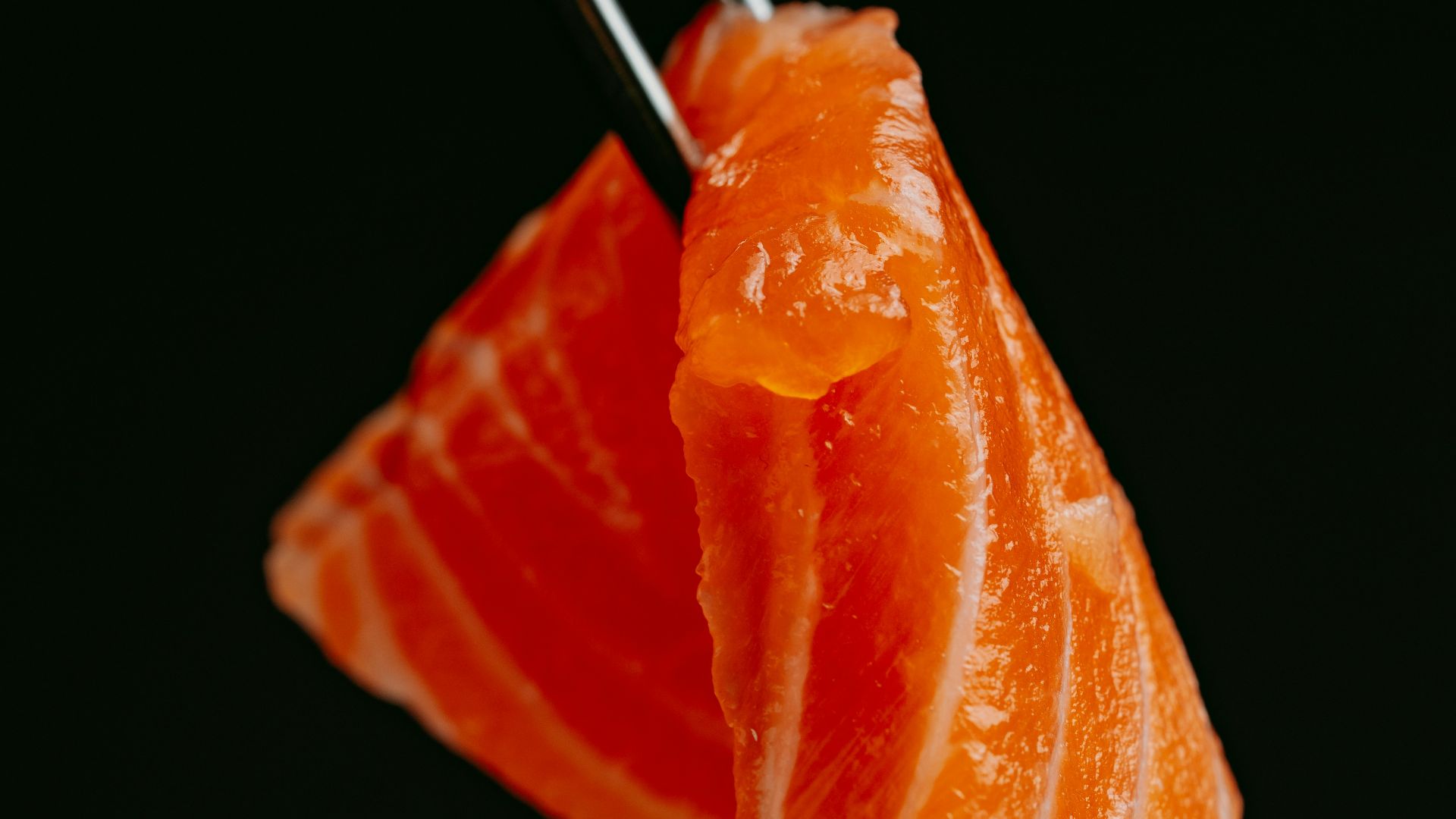 a piece of sushi with chopsticks sticking out of it