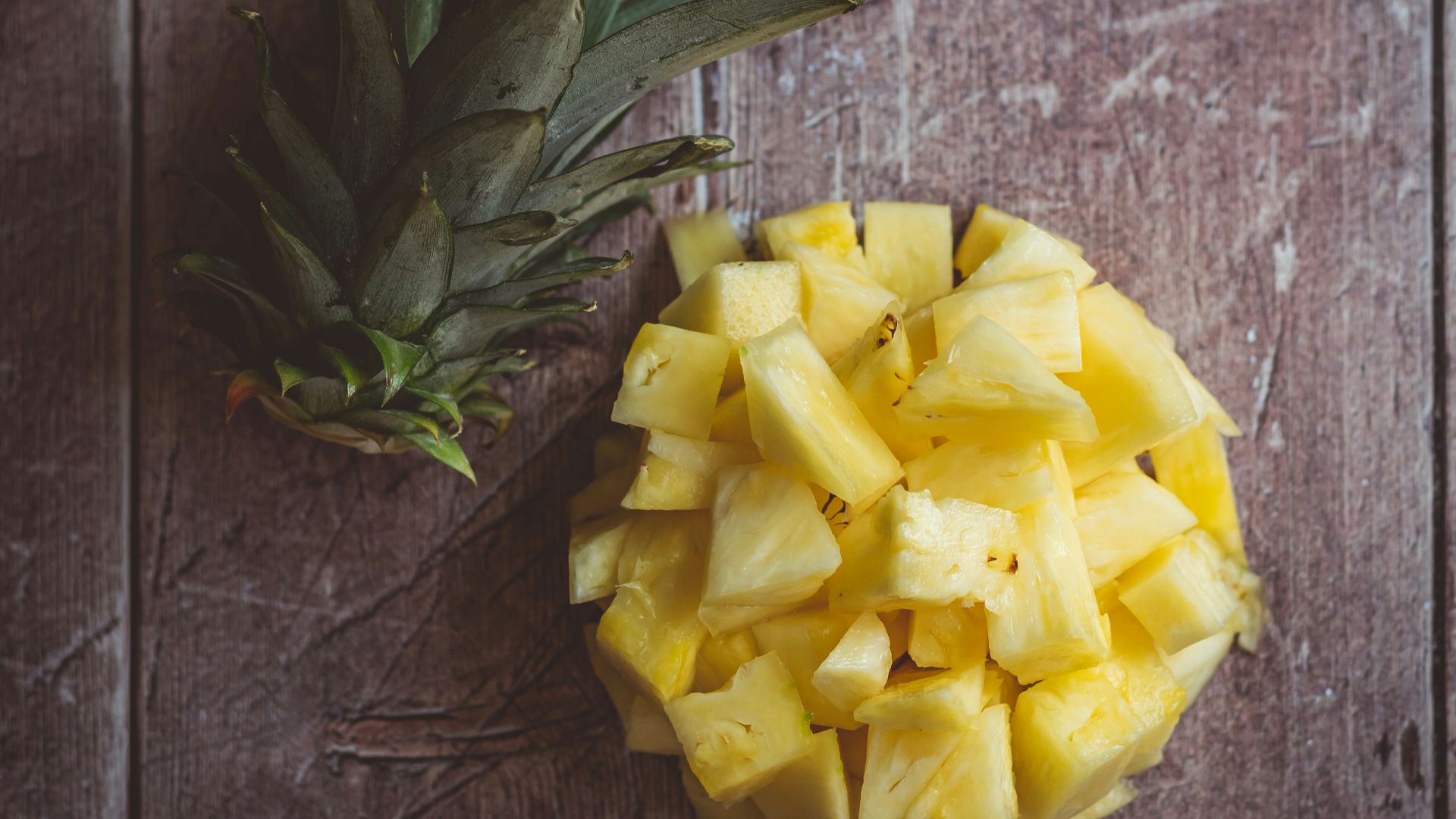 yellow rose on brown wooden table