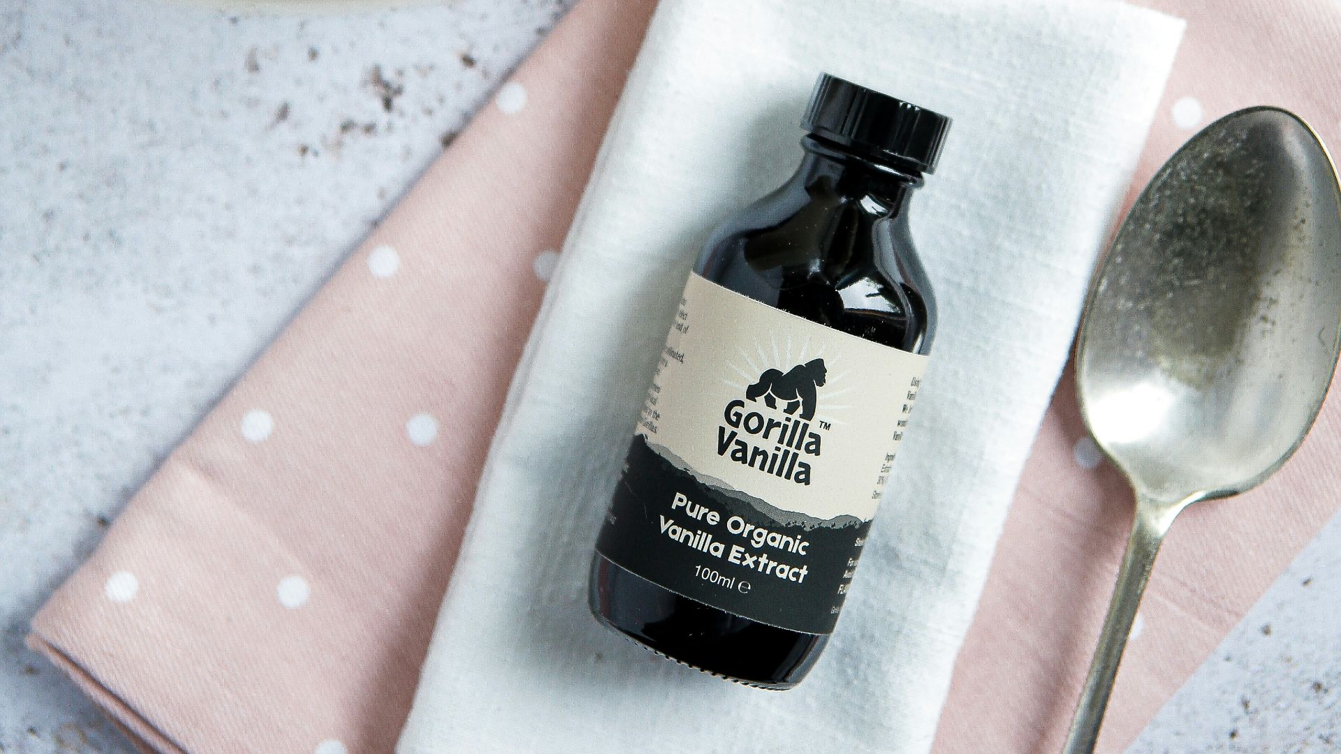 stainless steel spoon beside black glass bottle