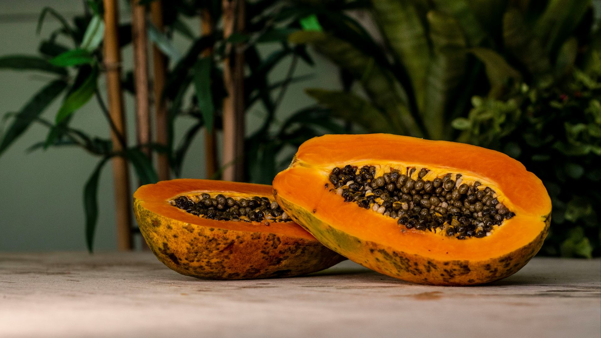 sliced papaya fruits on brown surface