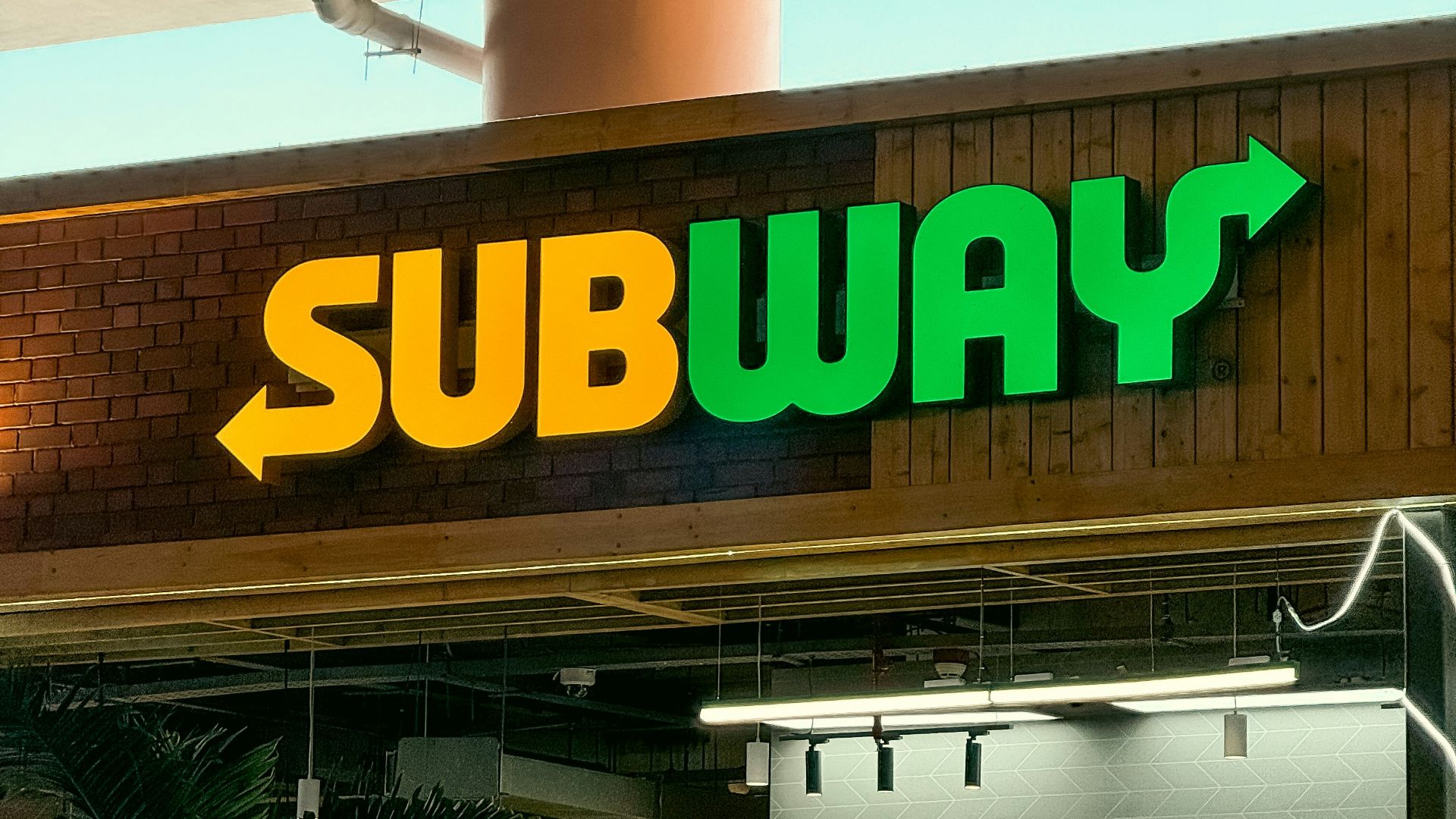 a subway sign above a subway entrance
