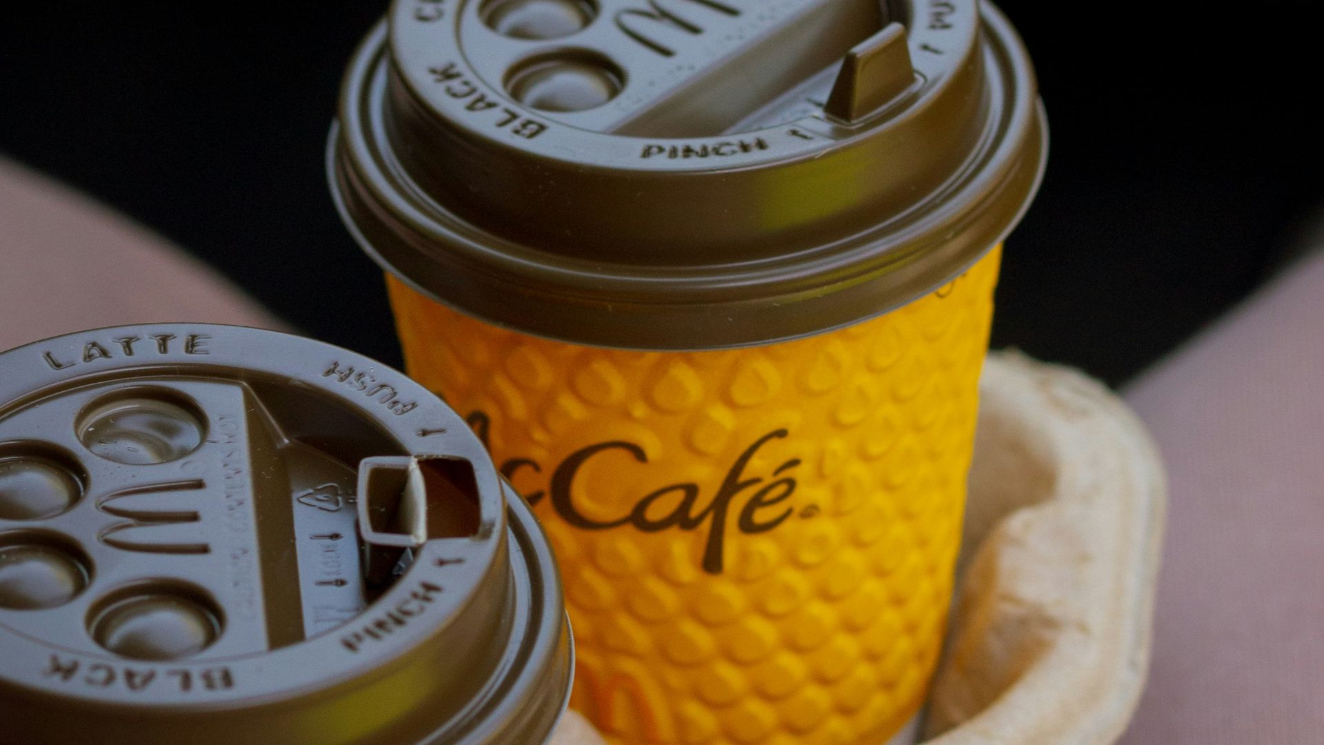 two cups of coffee sitting on a tray