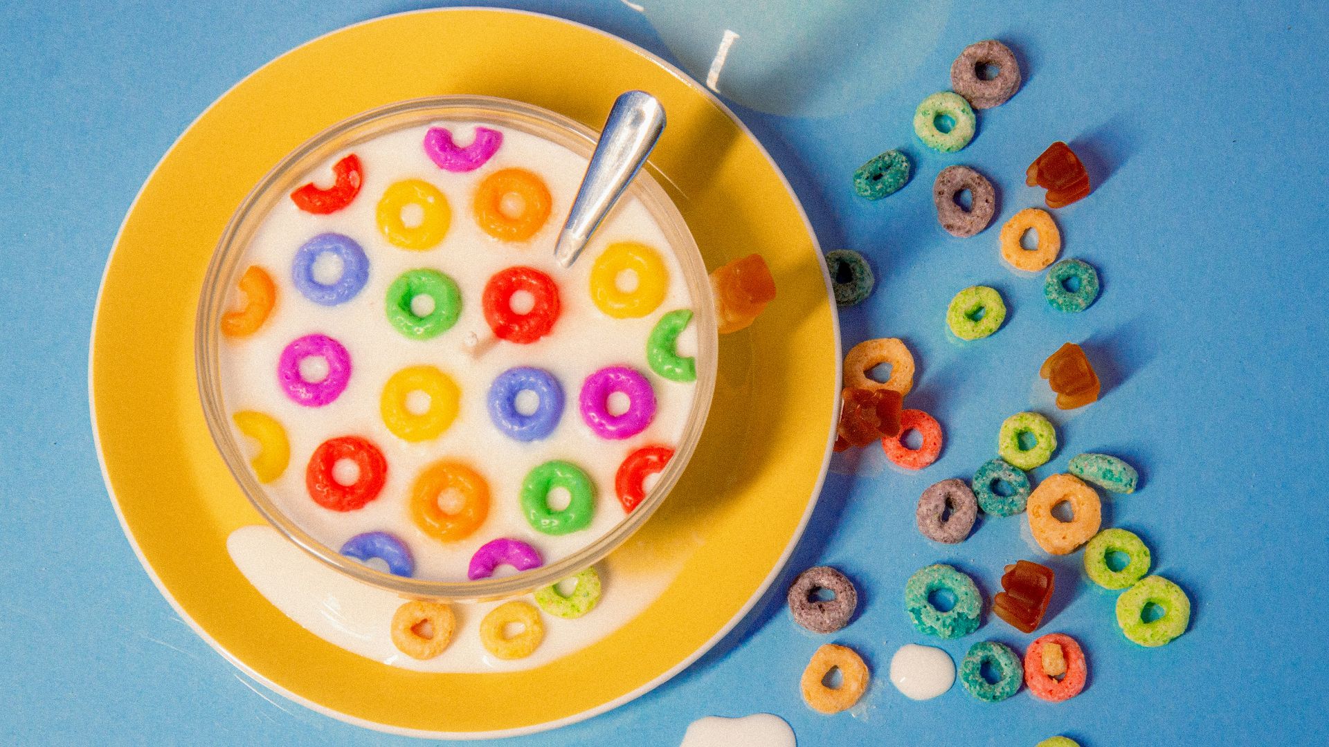 a bowl of cereal with a spoon on a plate
