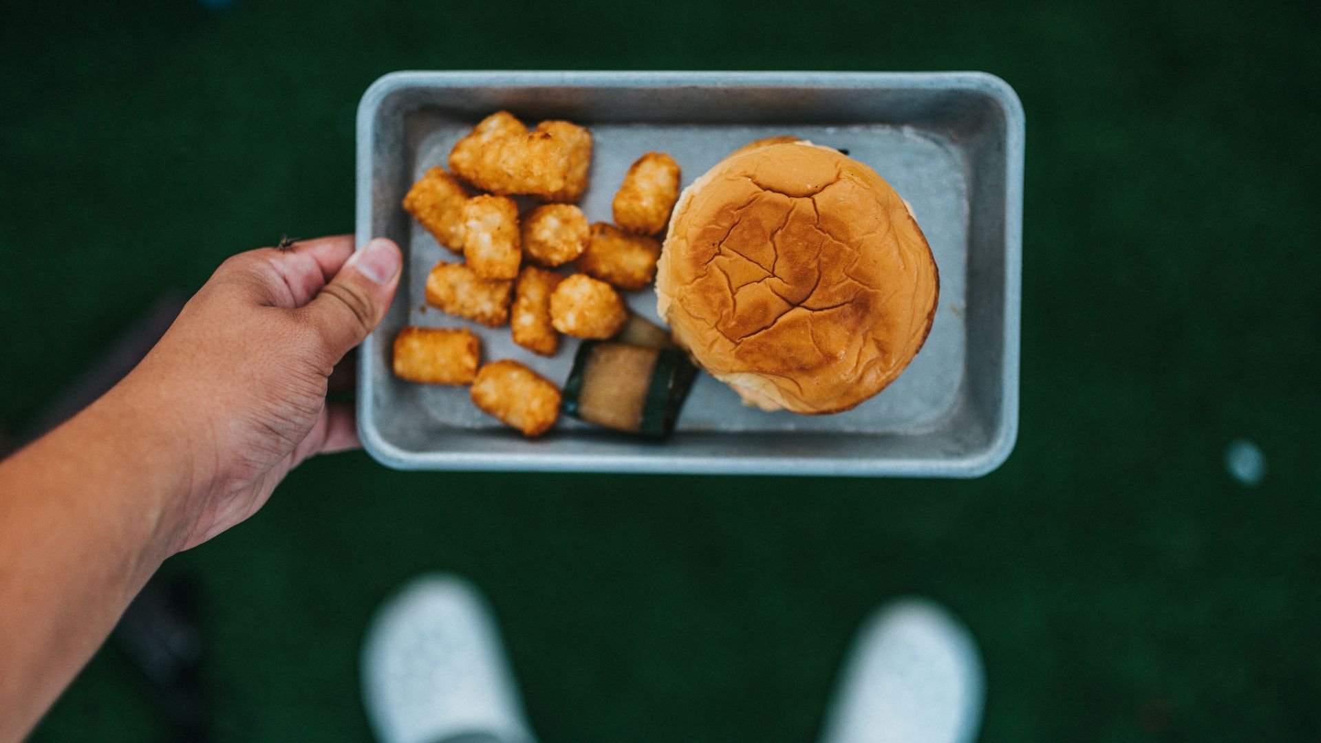 person holding tray with fried food
