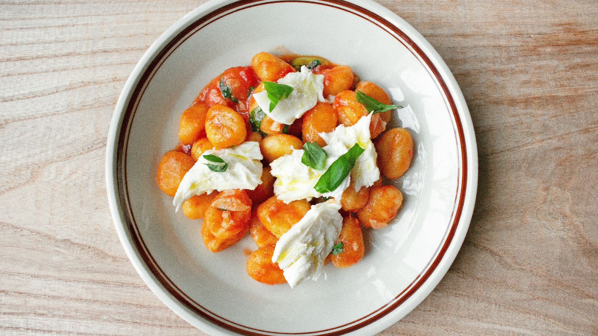 a white plate topped with food on top of a wooden table