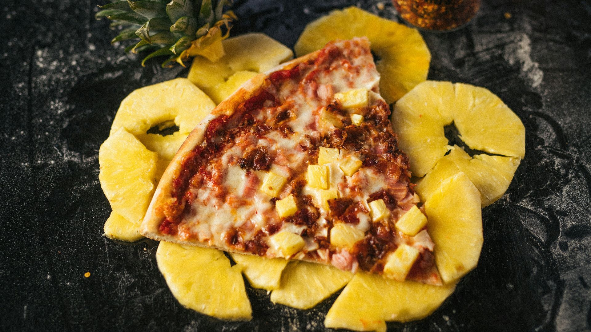 a piece of pizza with pineapple on top of it