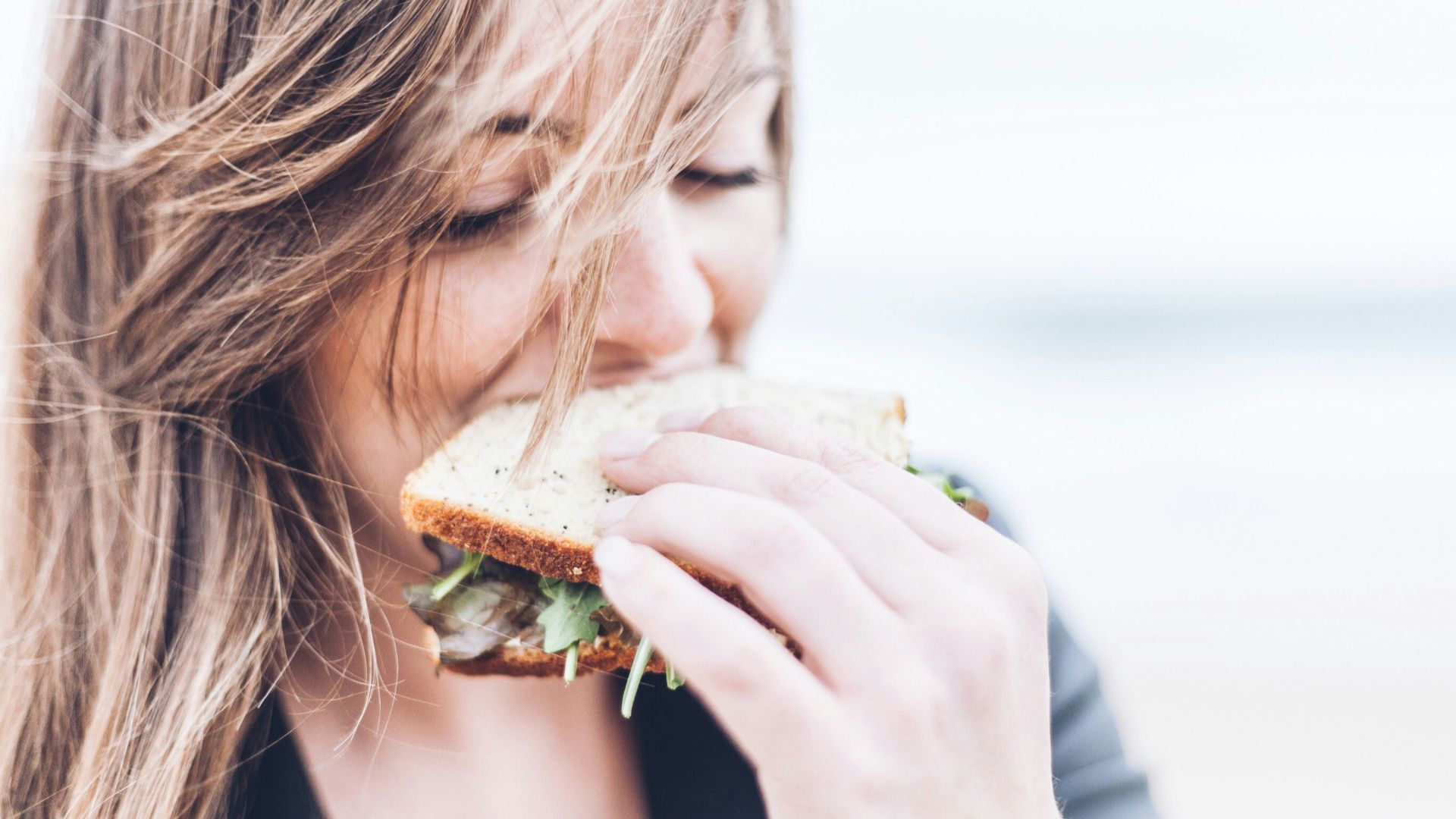 woman eating sandwich