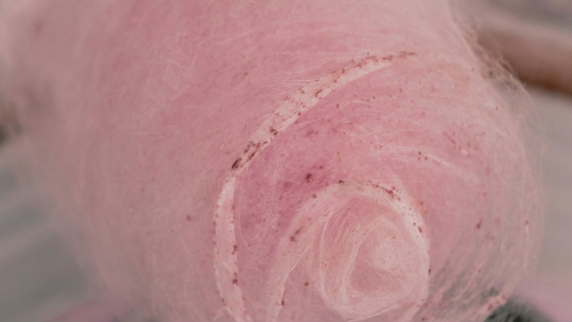 a pink ball of yarn is in a bowl