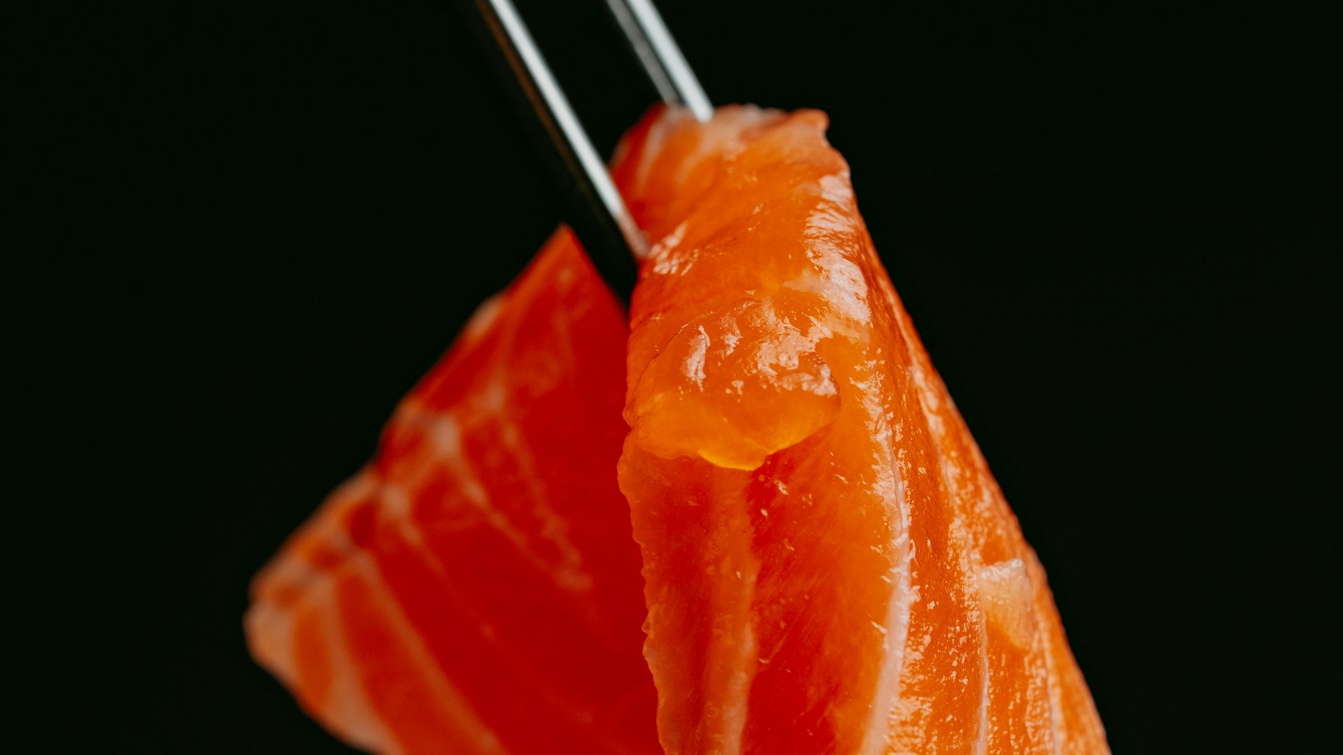 a piece of sushi with chopsticks sticking out of it