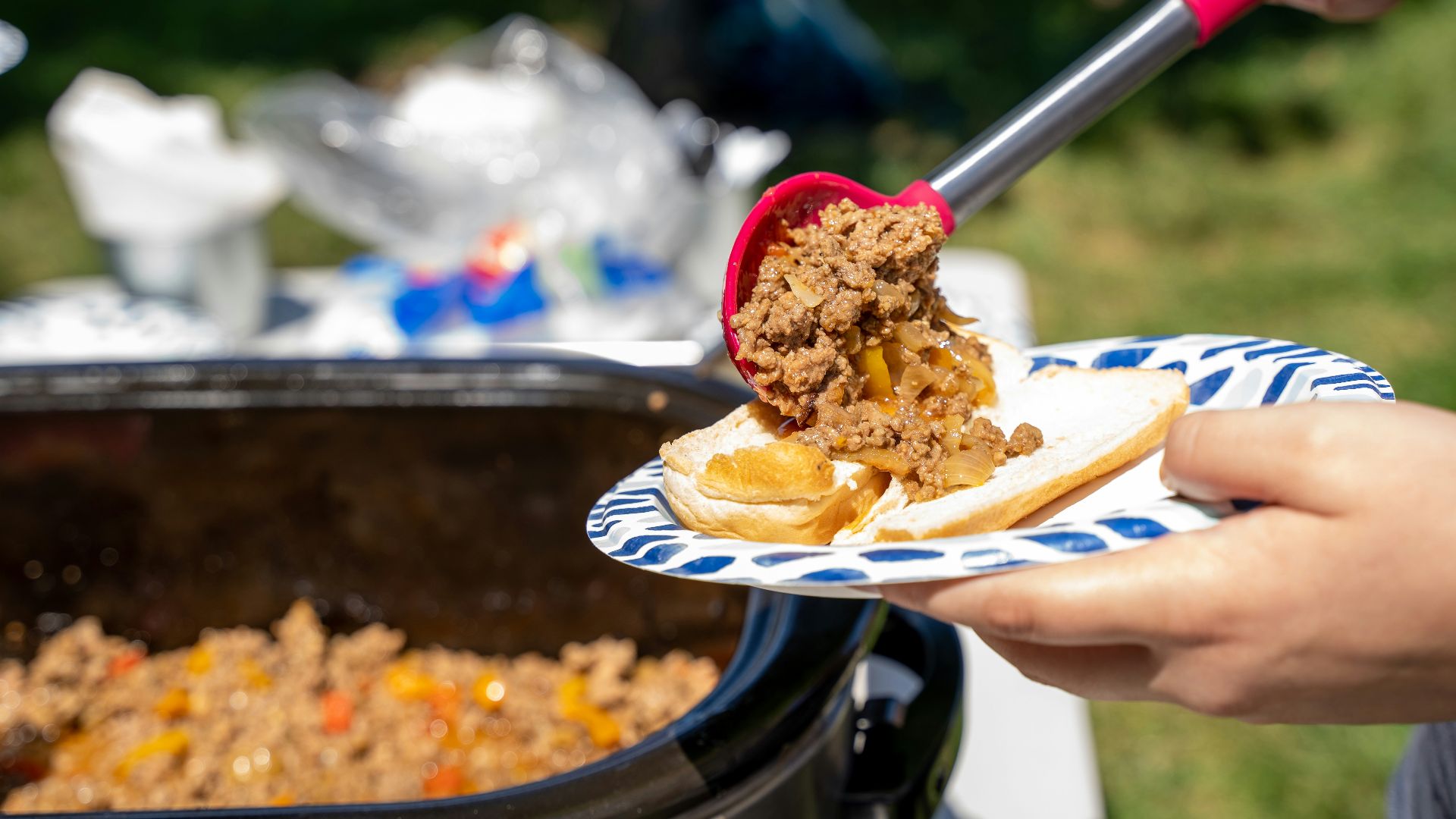 a person cutting a cake with a knife