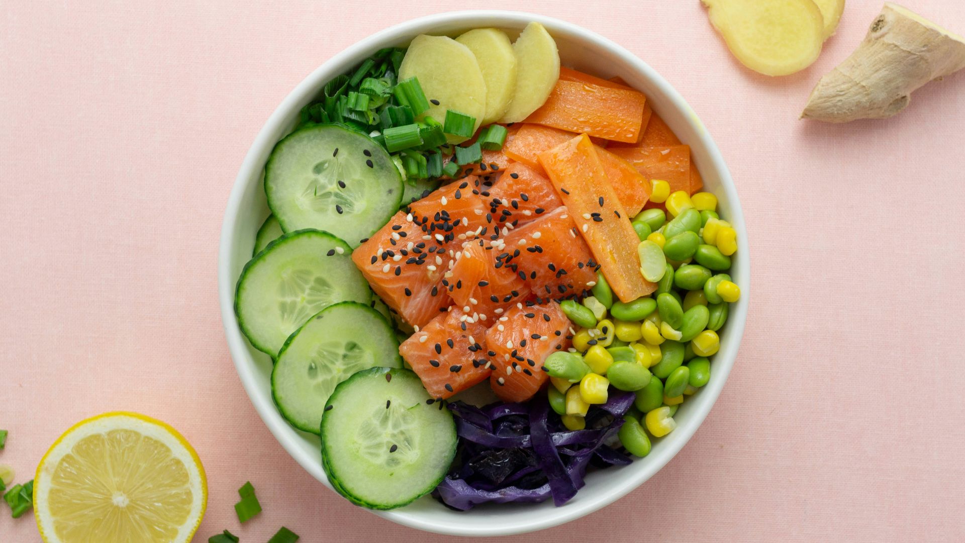 sliced cucumber and sliced lemon on white ceramic bowl