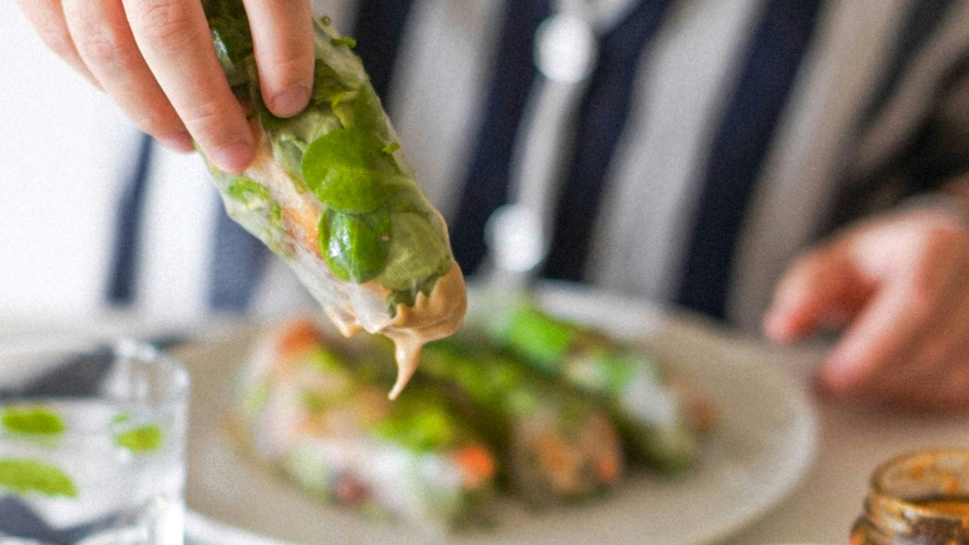 a person putting a piece of food on top of a plate