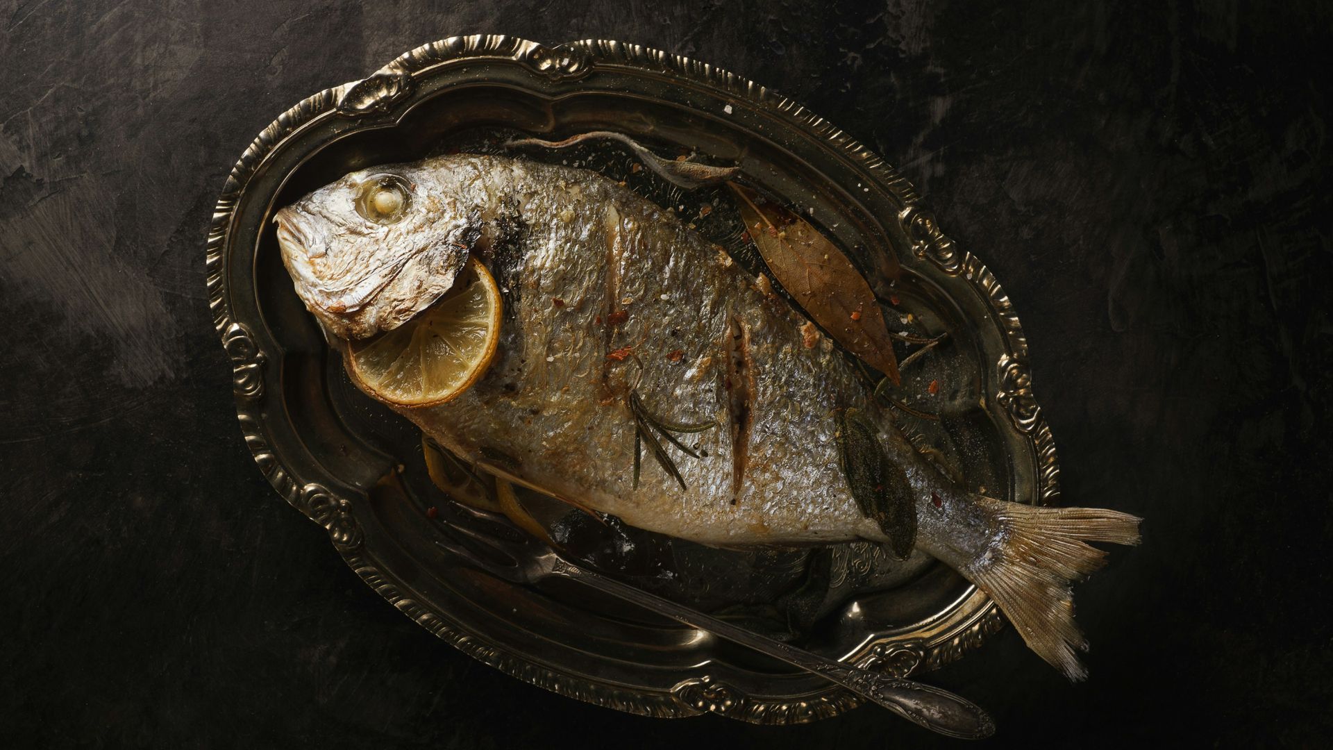 fried fish with lemon in plate