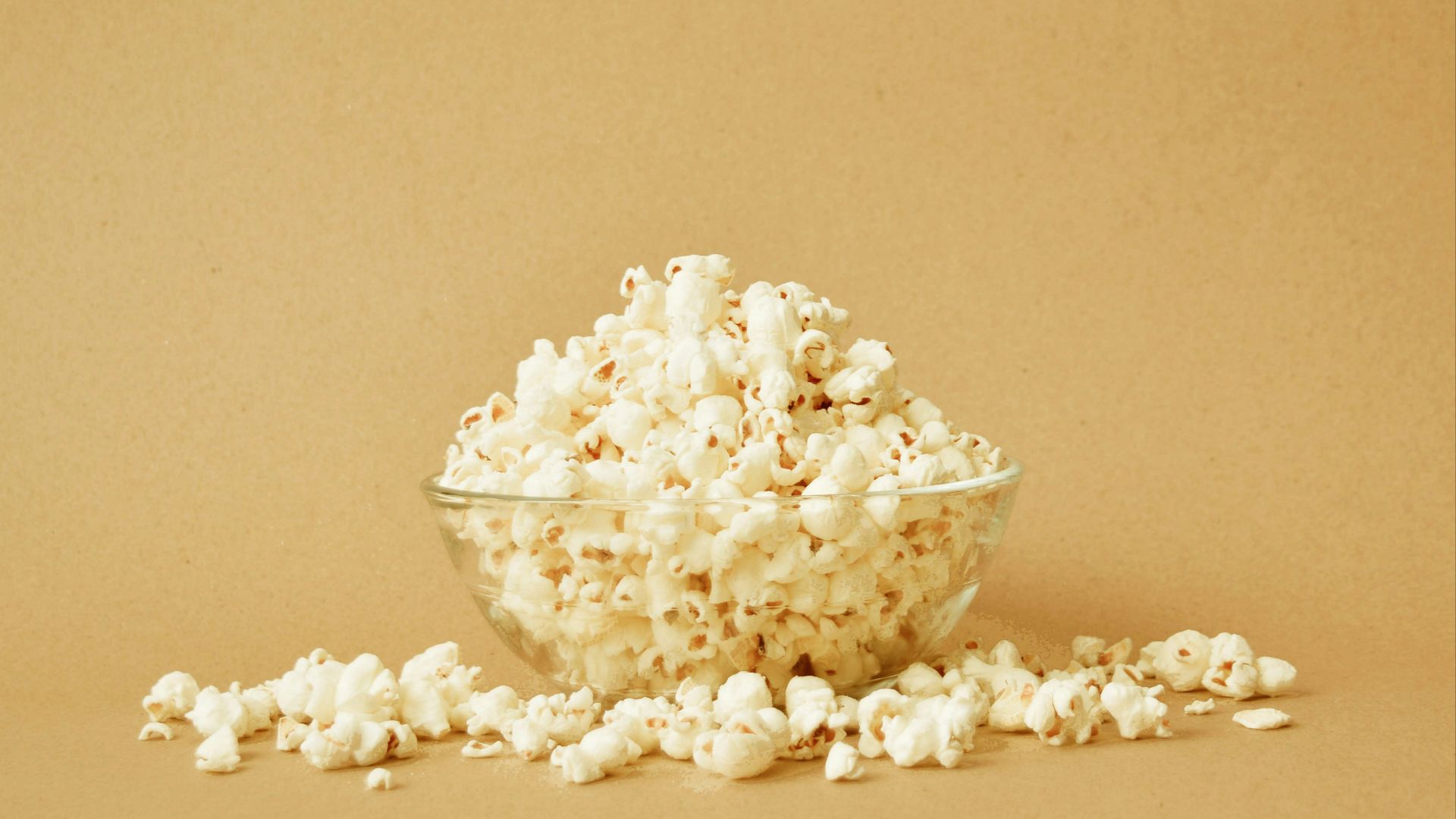 a bowl filled with popcorn sitting on top of a table