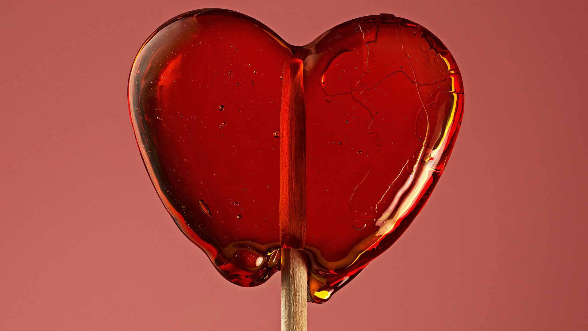 A heart shaped lollipop on a stick