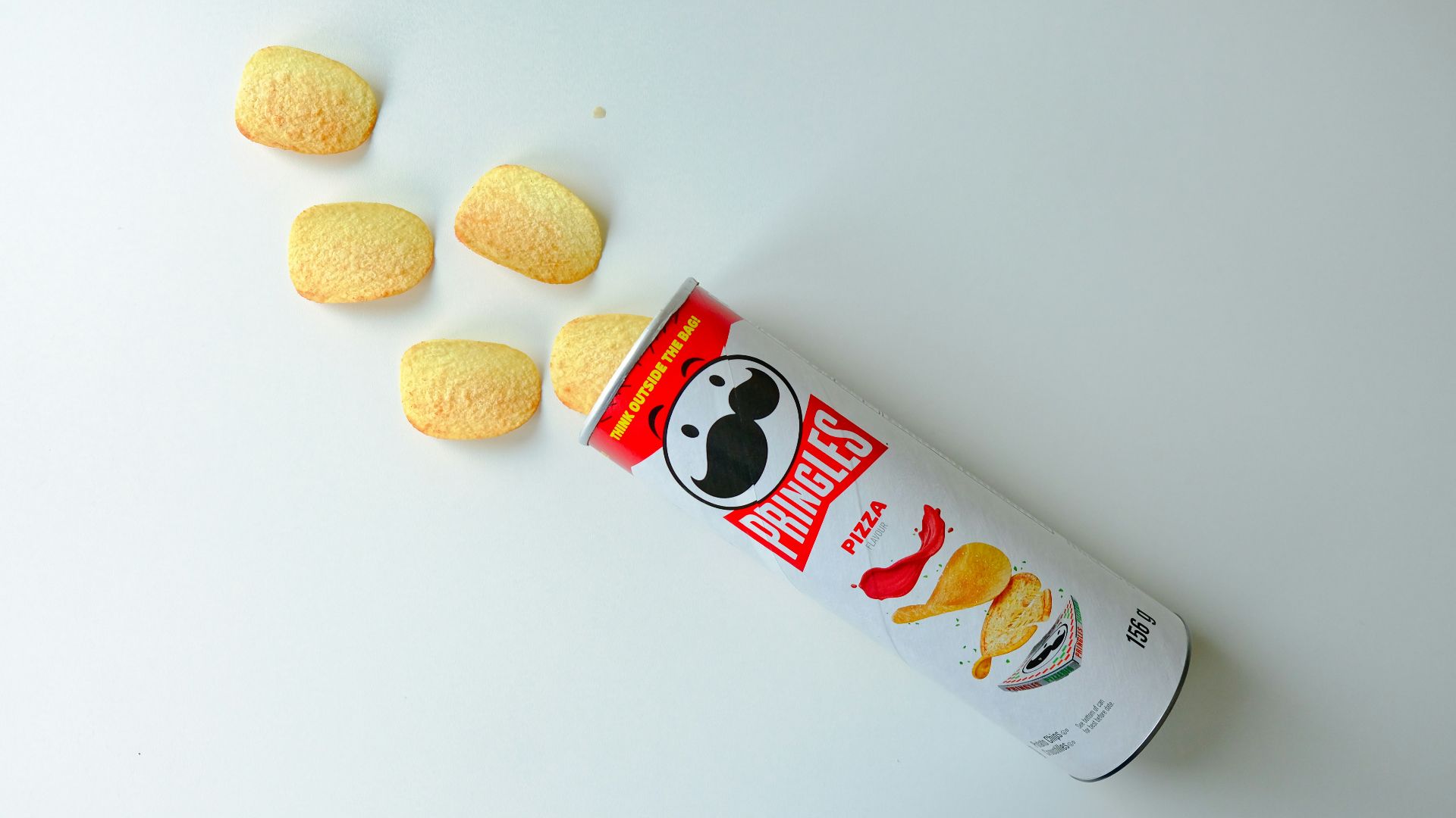 a can of macaroni and cheese on a white surface