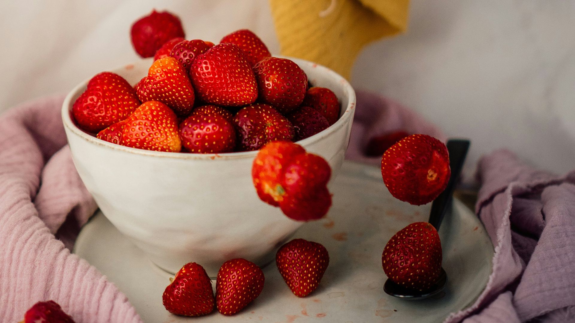 person holding red raspberry fruit