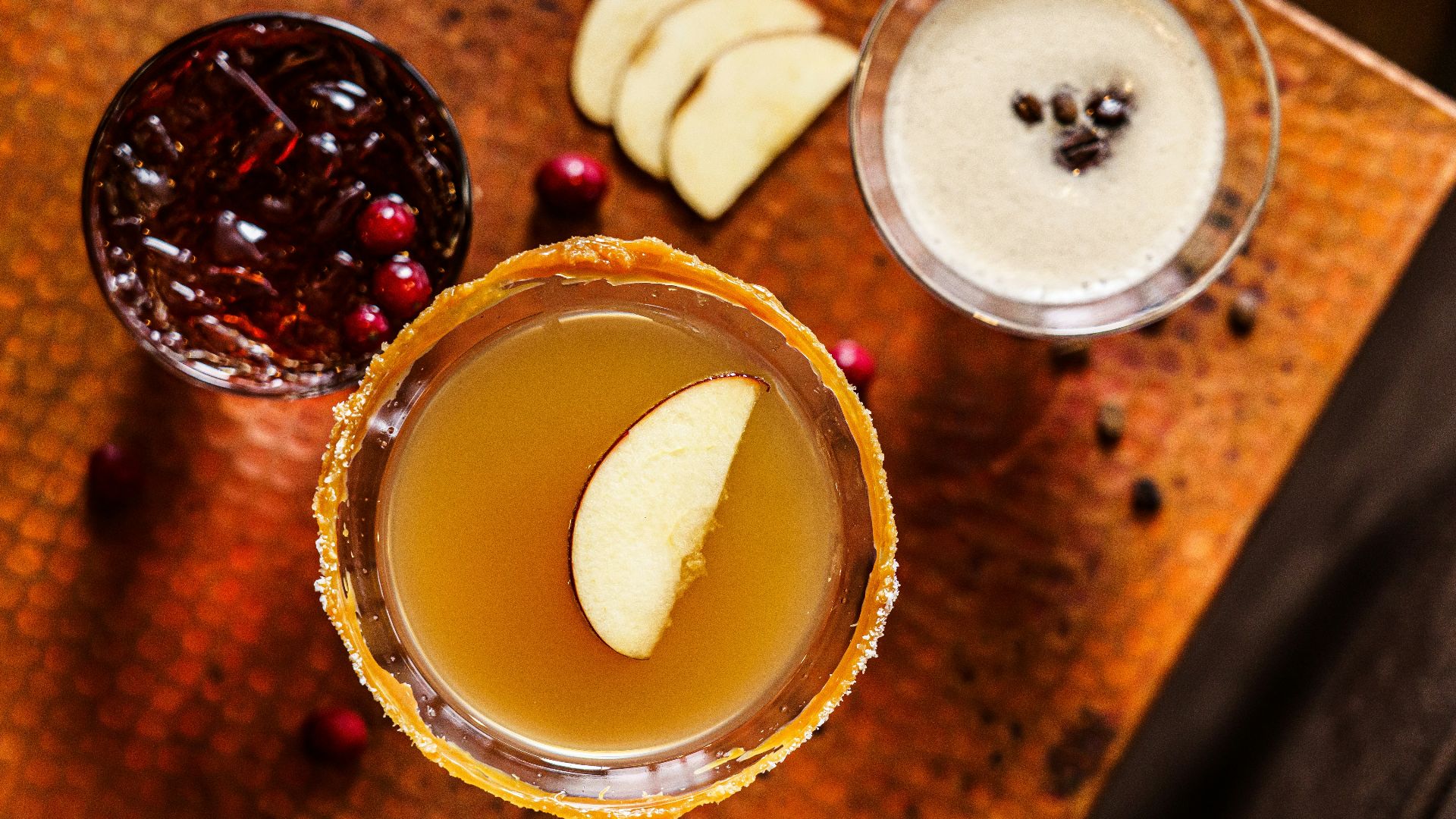 a couple of glasses filled with drinks on top of a table