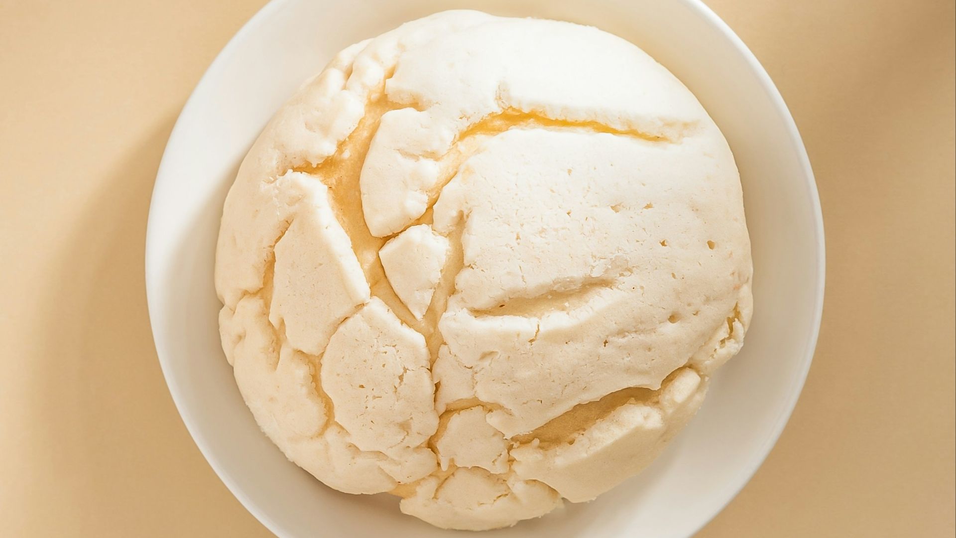 a white bowl filled with food on top of a table