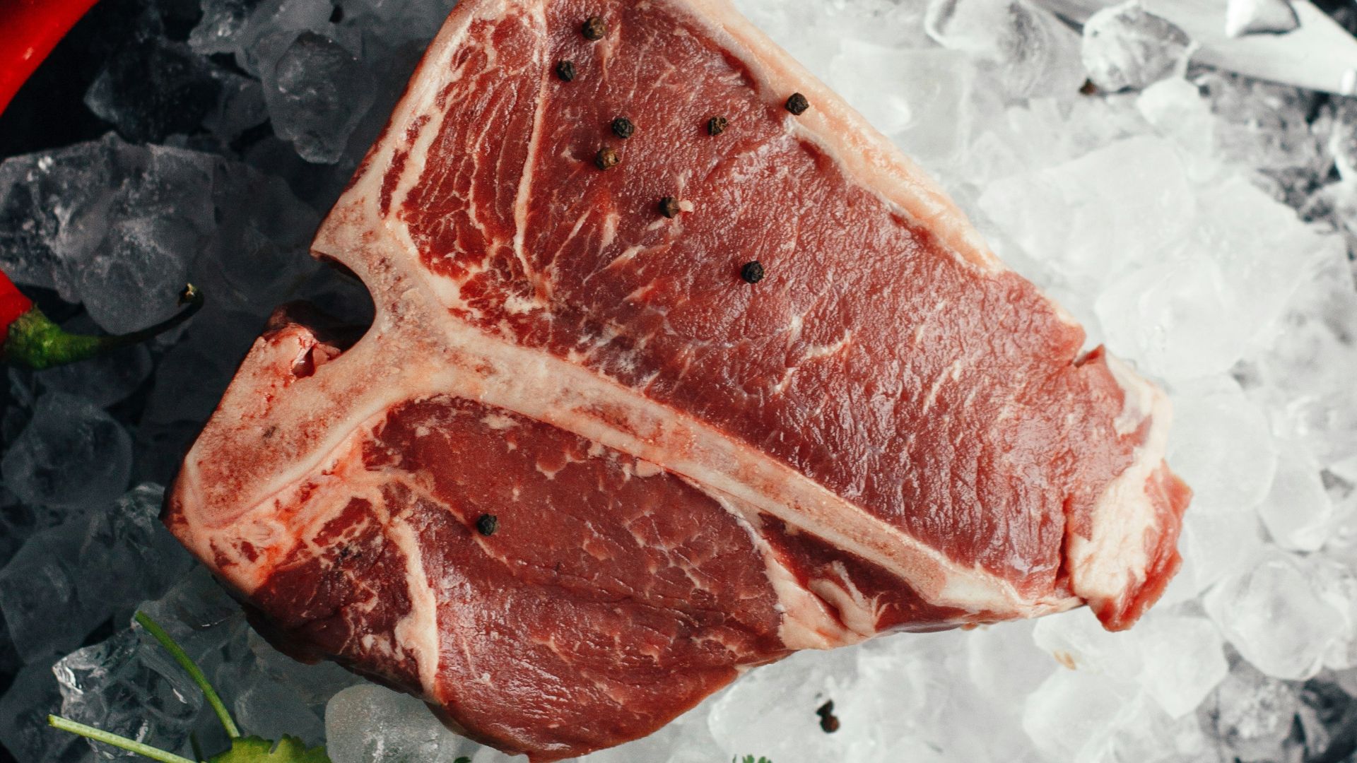 raw meat on ice with coriander and chilis